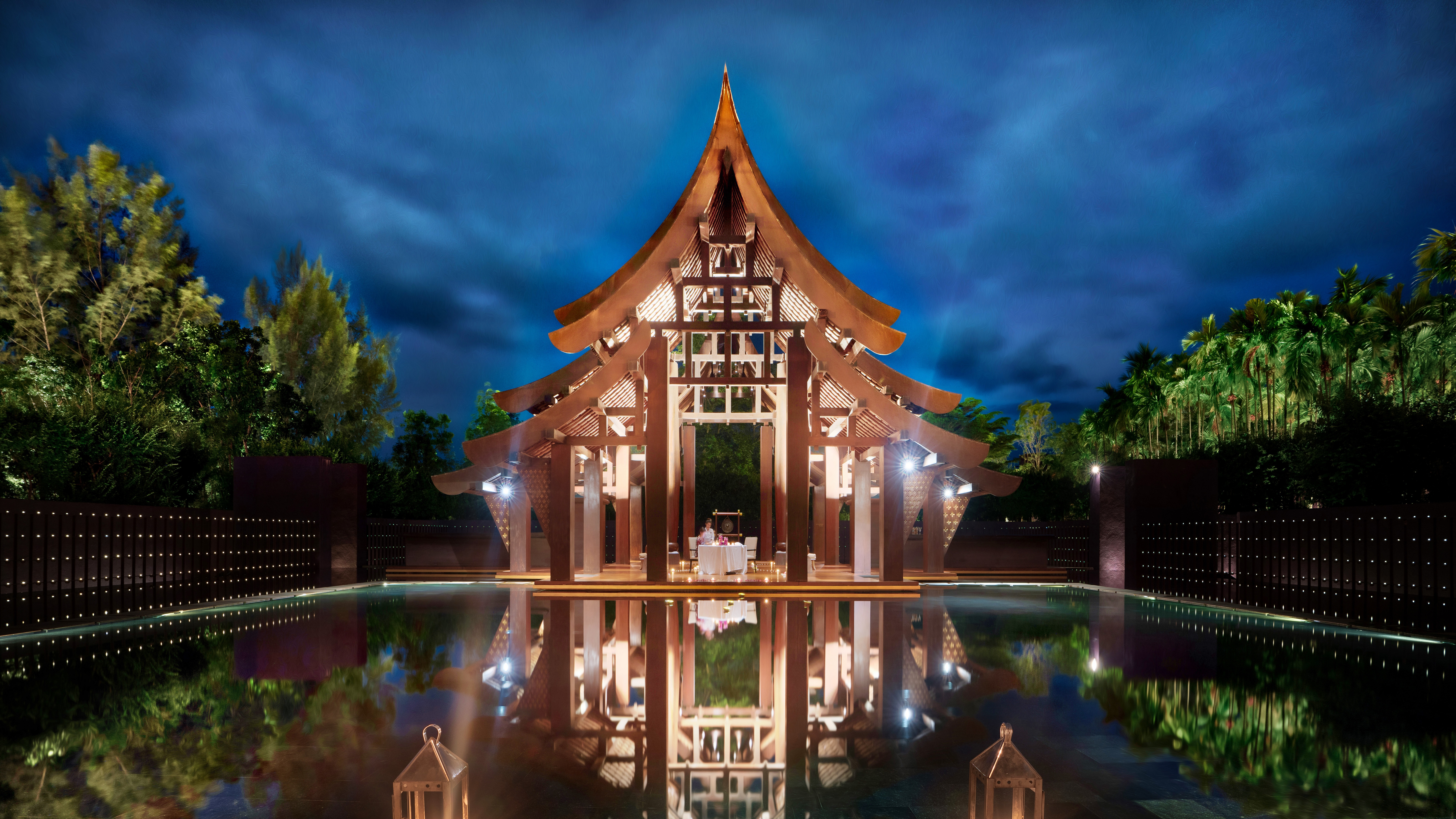 Thai pavilion reflected in water at night HD Wallpaper
