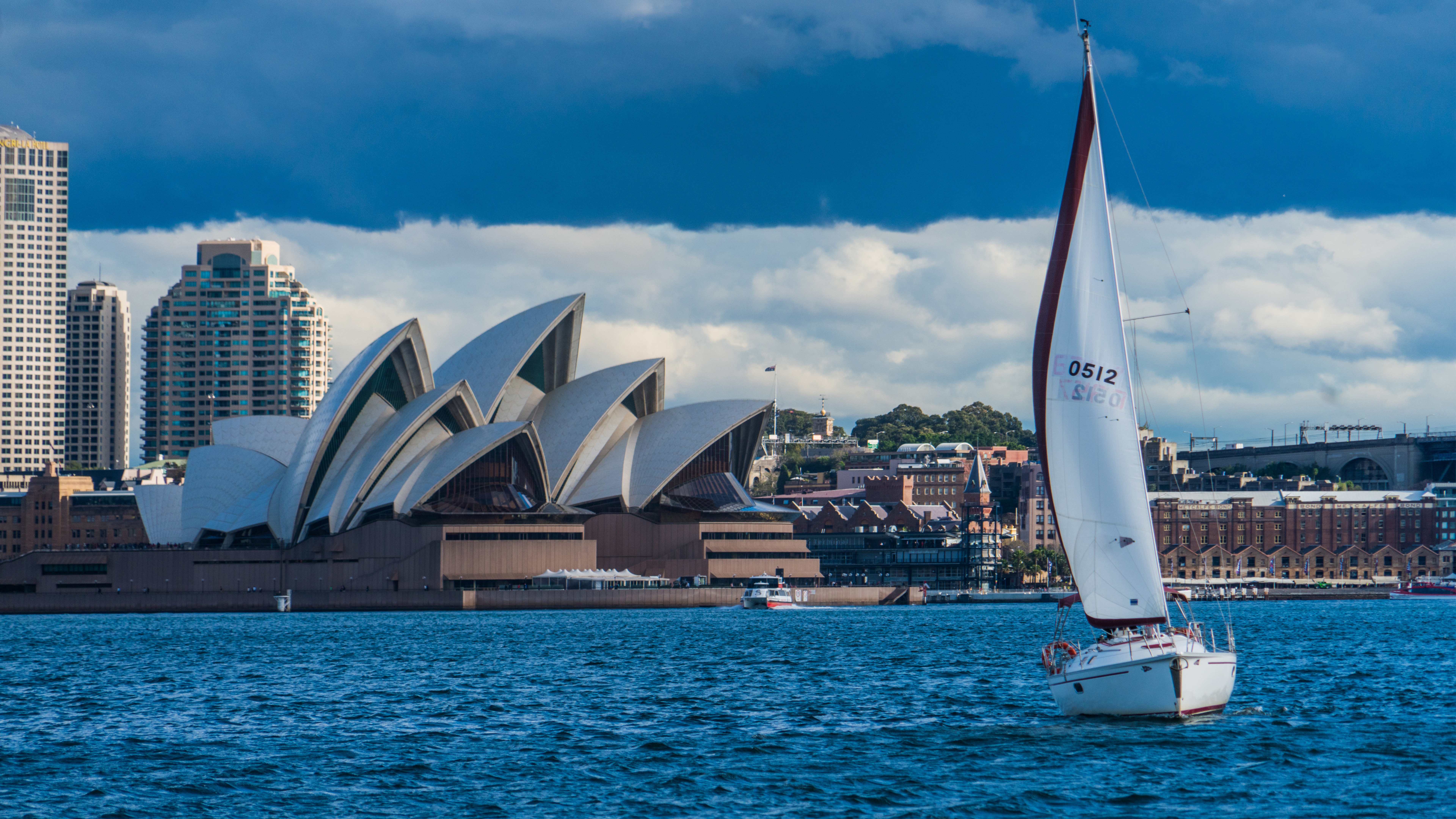 Sydney Opera House and sailboat in harbor HD Wallpaper