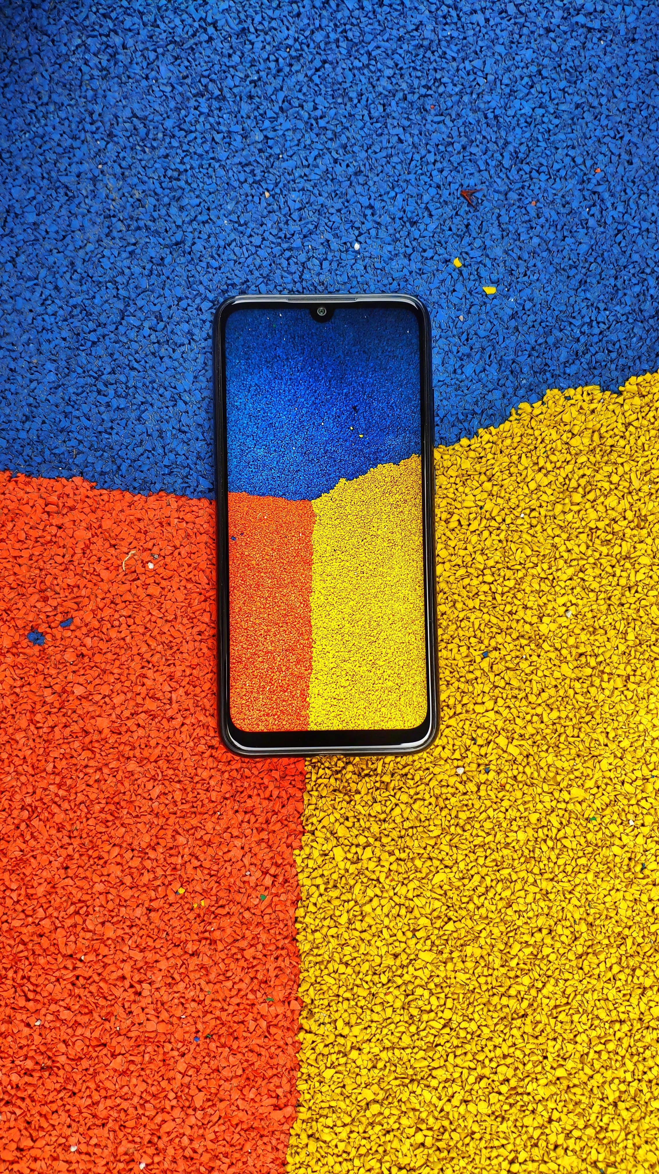 Smartphone on colorful textured surface HD Phone Wallpaper