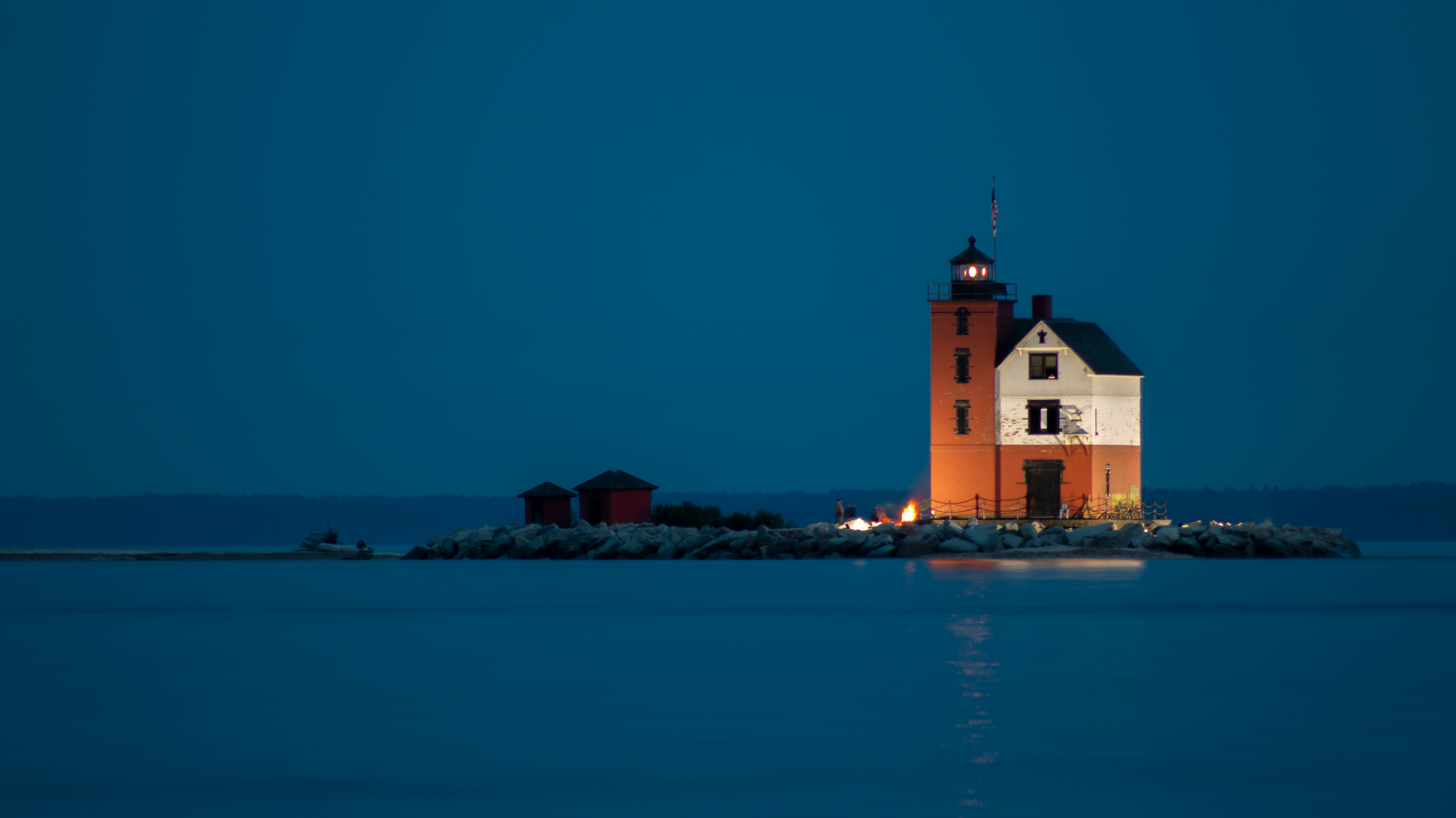 Lighthouse on an island at dusk HD Wallpaper