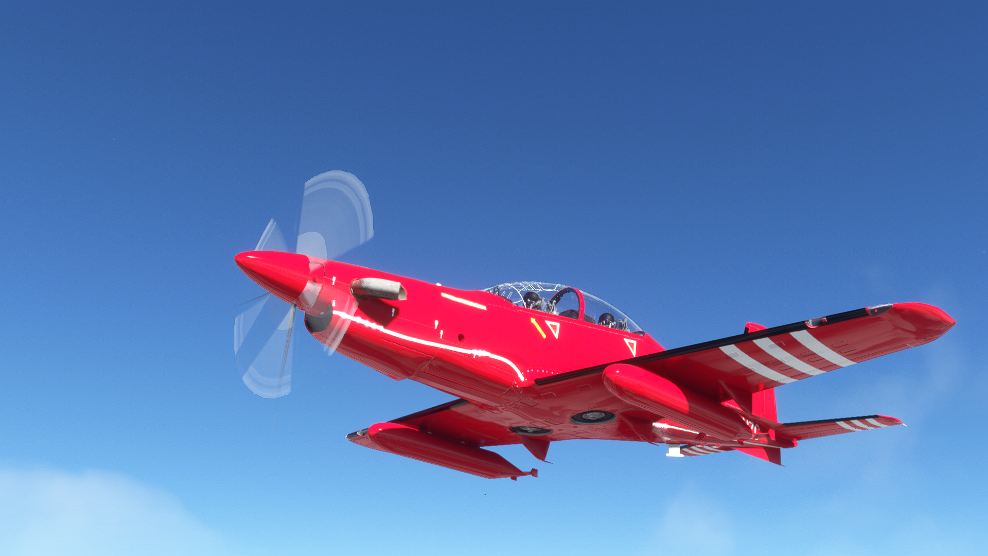 Red Pilatus PC-21 aircraft flying in blue sky HD Wallpaper