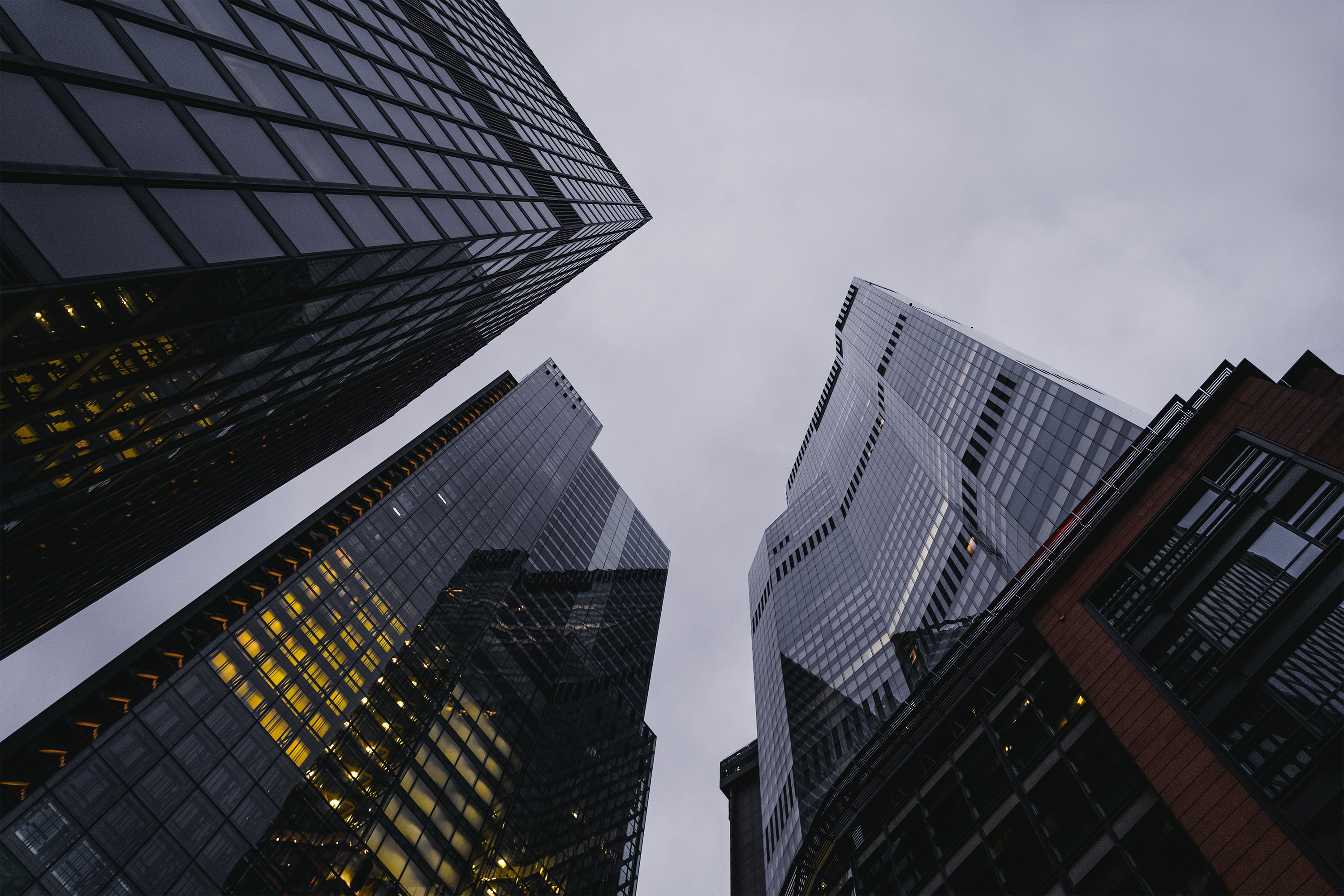 Skyscrapers in a city against a cloudy sky HD Wallpaper