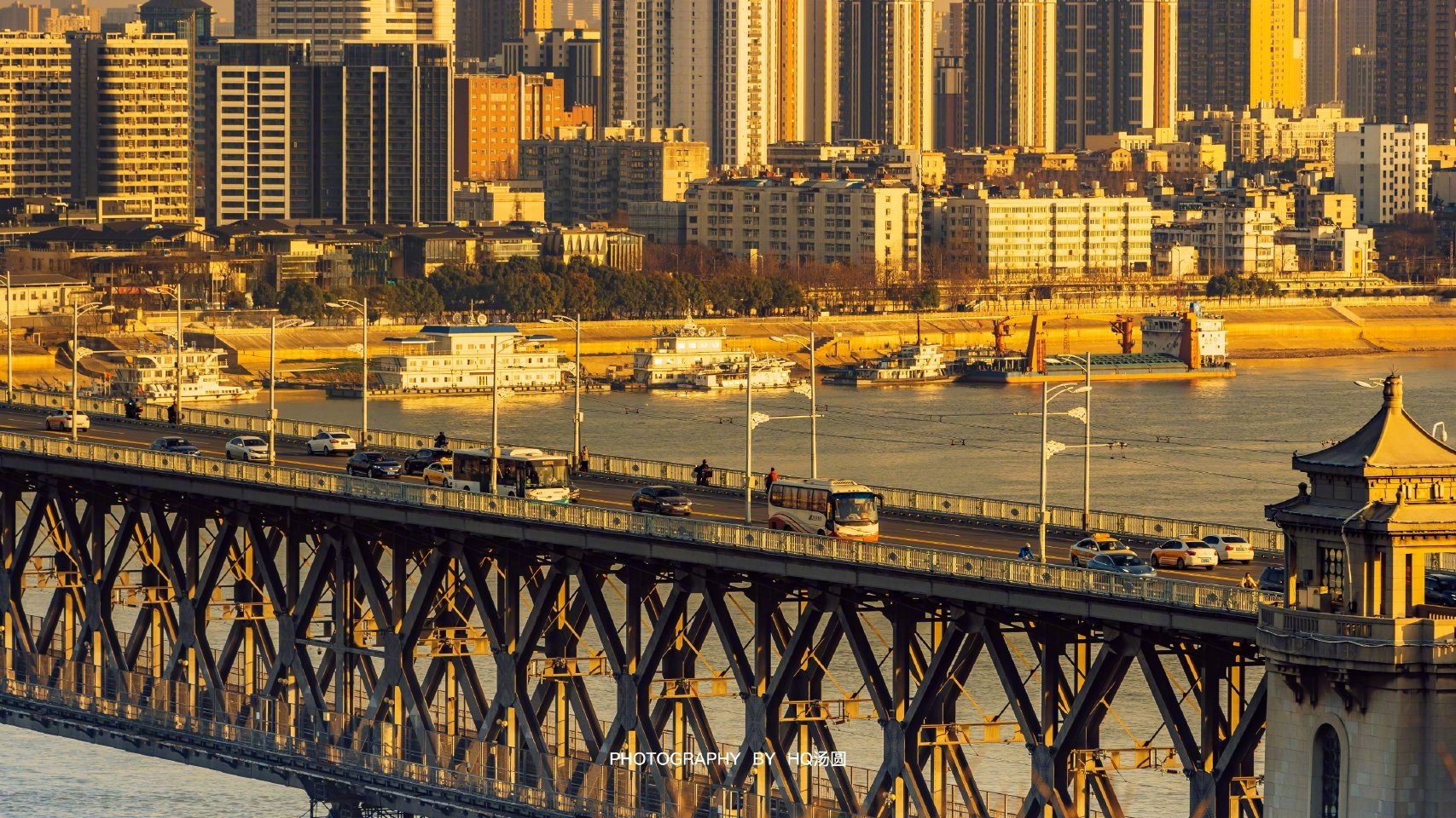 City skyline with a bridge and river at dusk HD Wallpaper