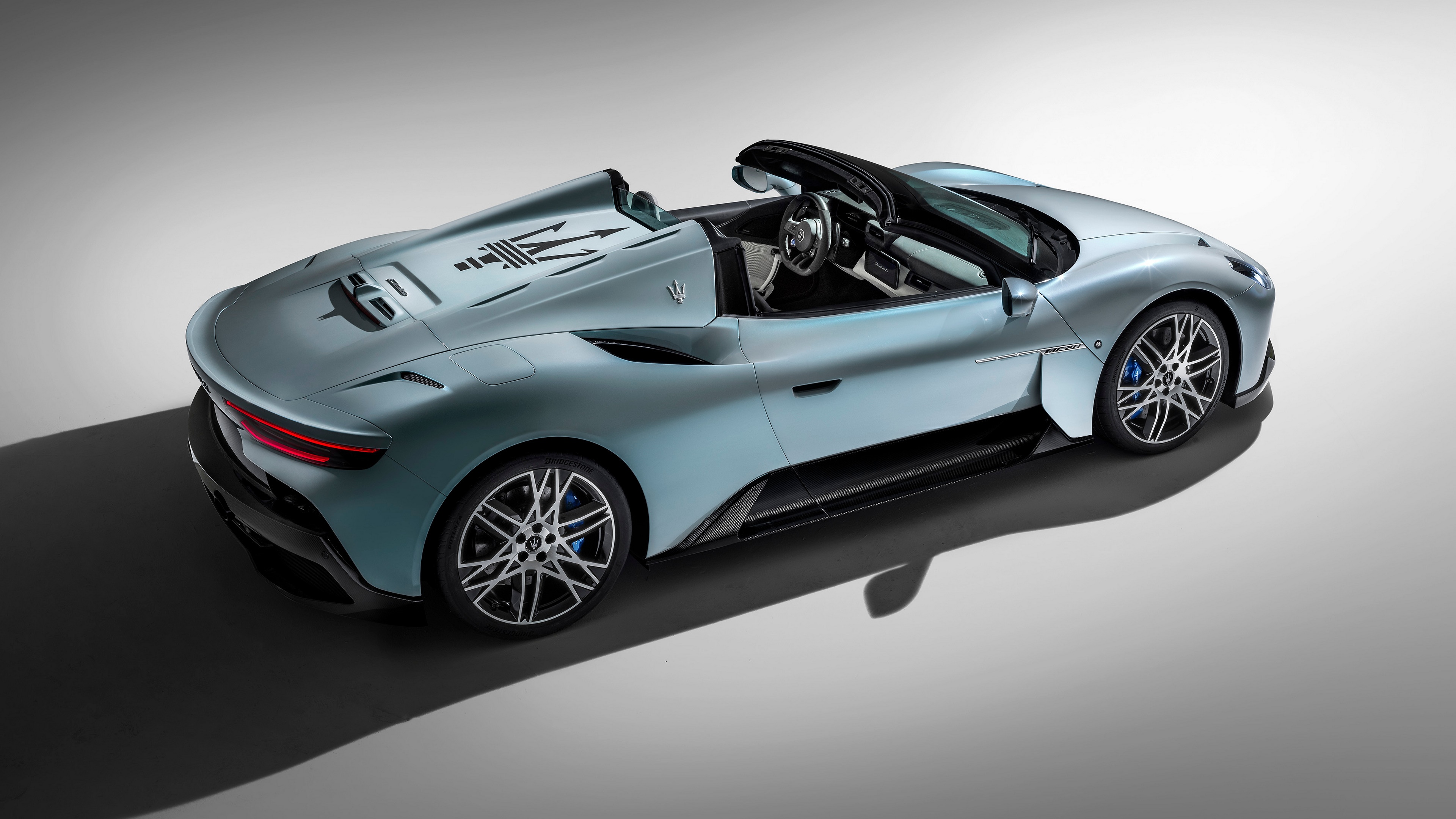 Maserati MC20 Cielo in light blue with trident logo HD Wallpaper