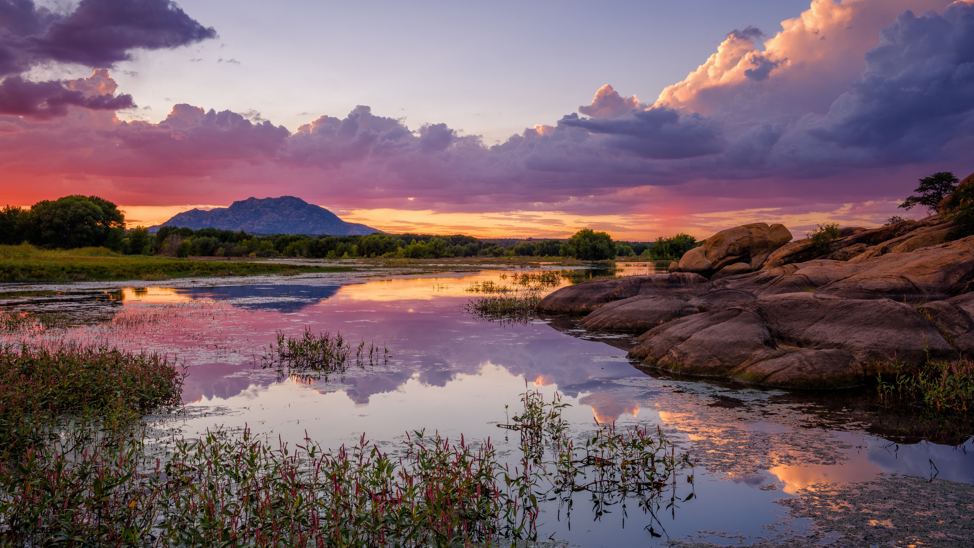 Sunset over a lake with mountains and rocks HD Wallpaper