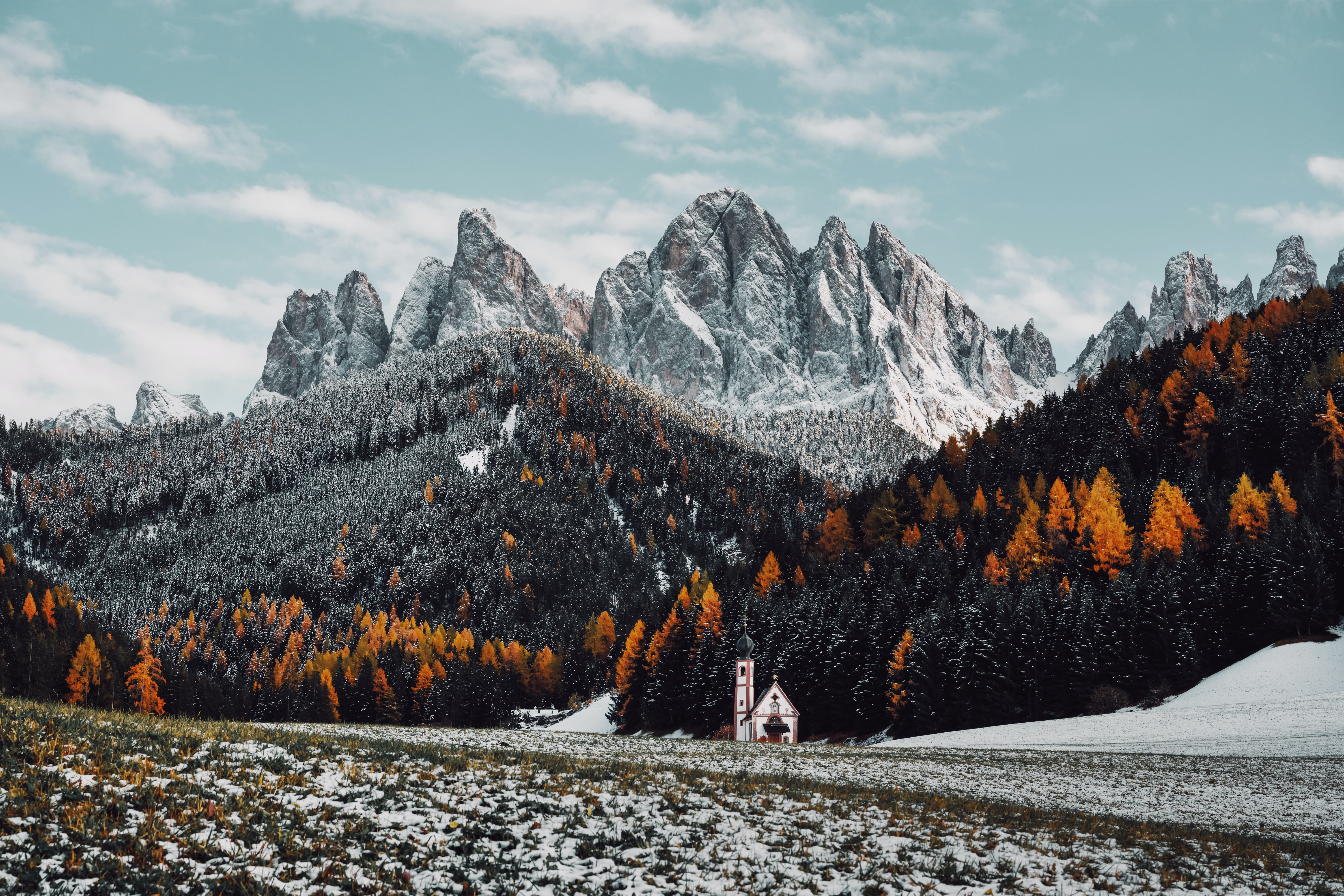4K snow-covered mountains with a church and autumn trees HD Wallpaper