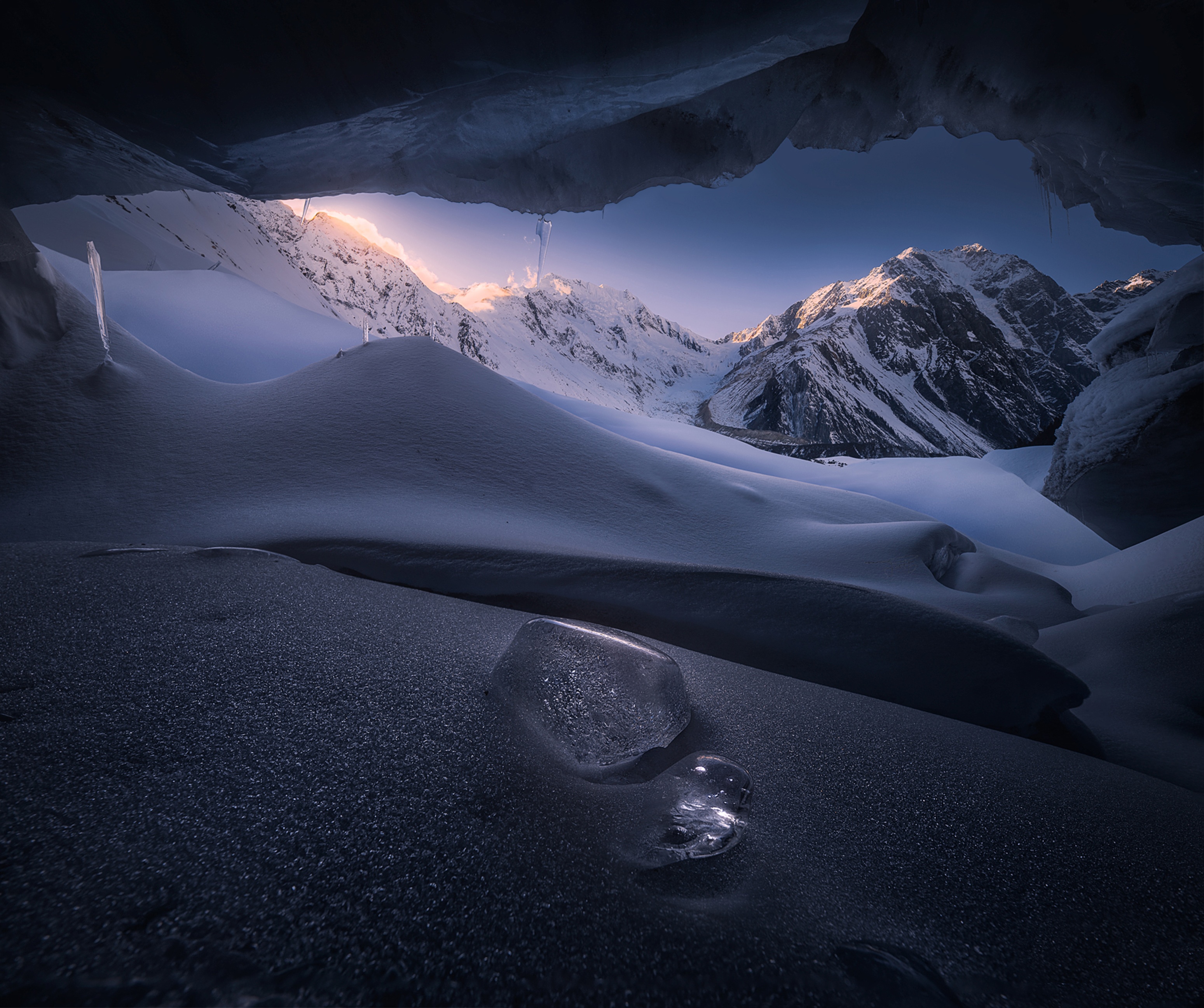 Snowy mountains seen from inside an ice cave in Tibet HD Wallpaper