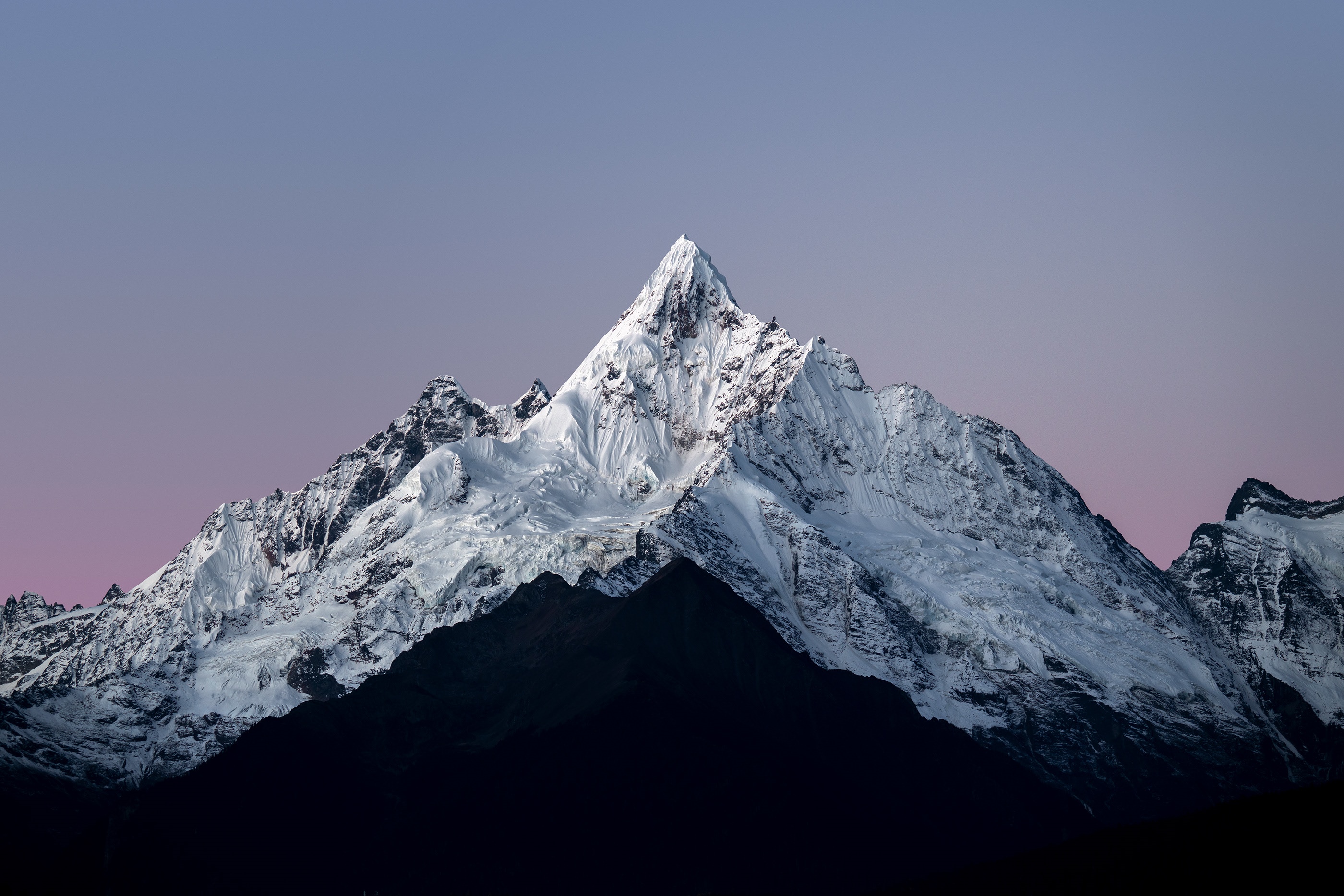 Snow-covered mountains under a twilight sky HD Wallpaper
