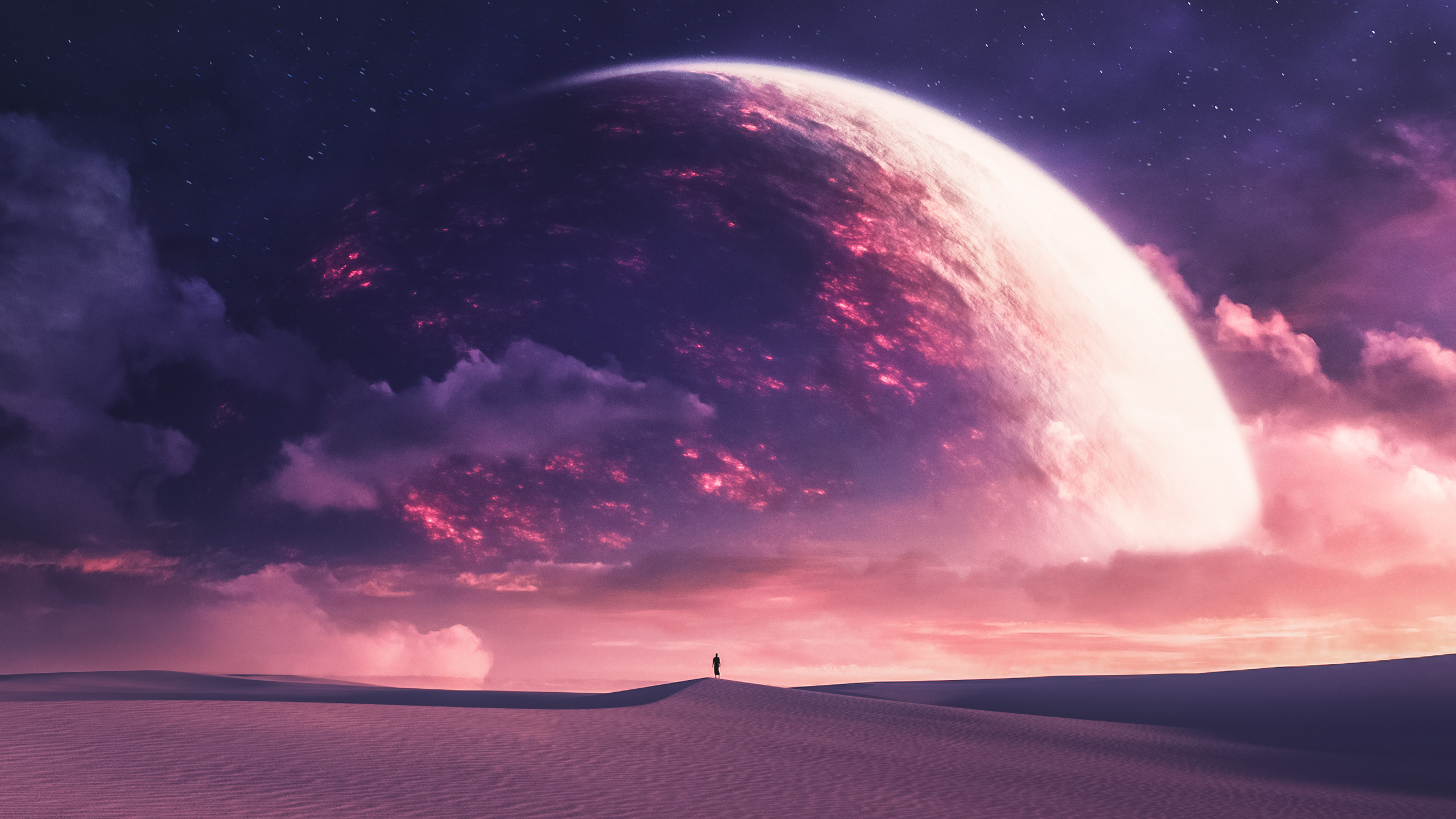 A lone figure stands on desert dunes under a giant planet HD Wallpaper