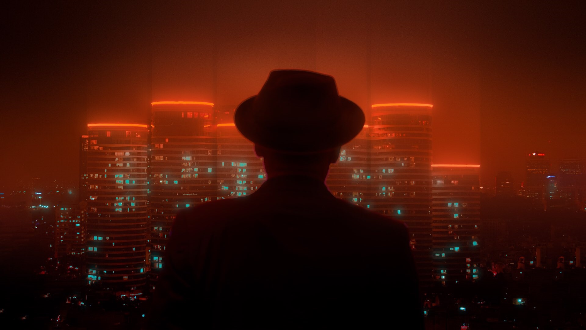 Silhouette of a man in a hat overlooking a neon cyberpunk cityscape HD Wallpaper