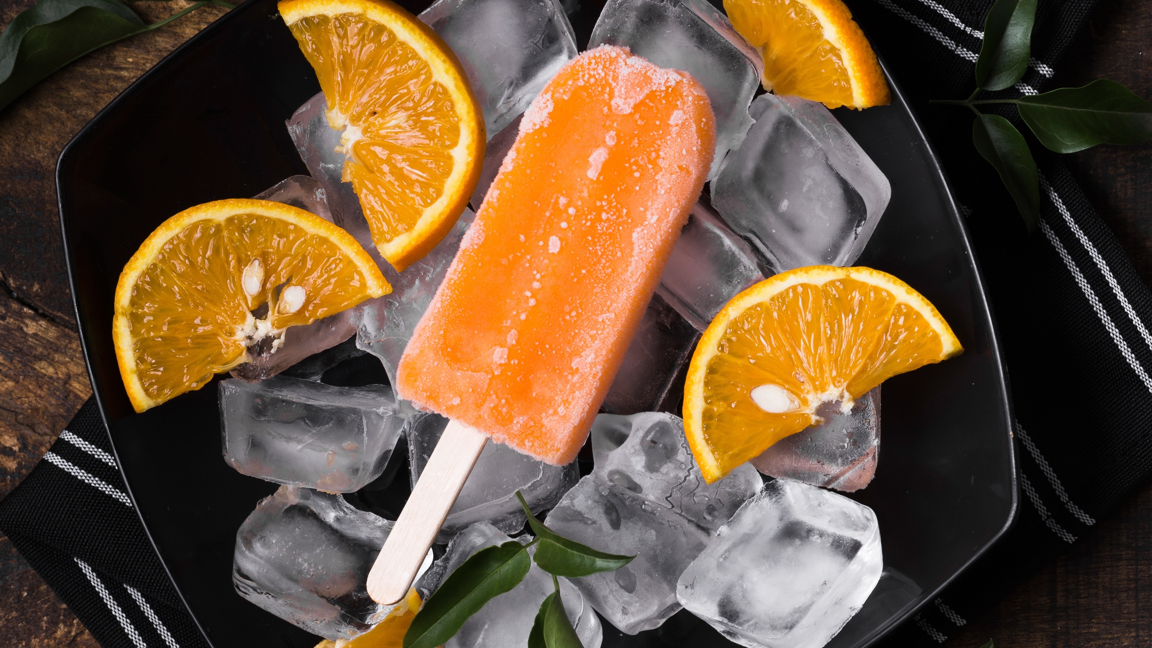 Orange popsicle with ice and orange slices HD Wallpaper