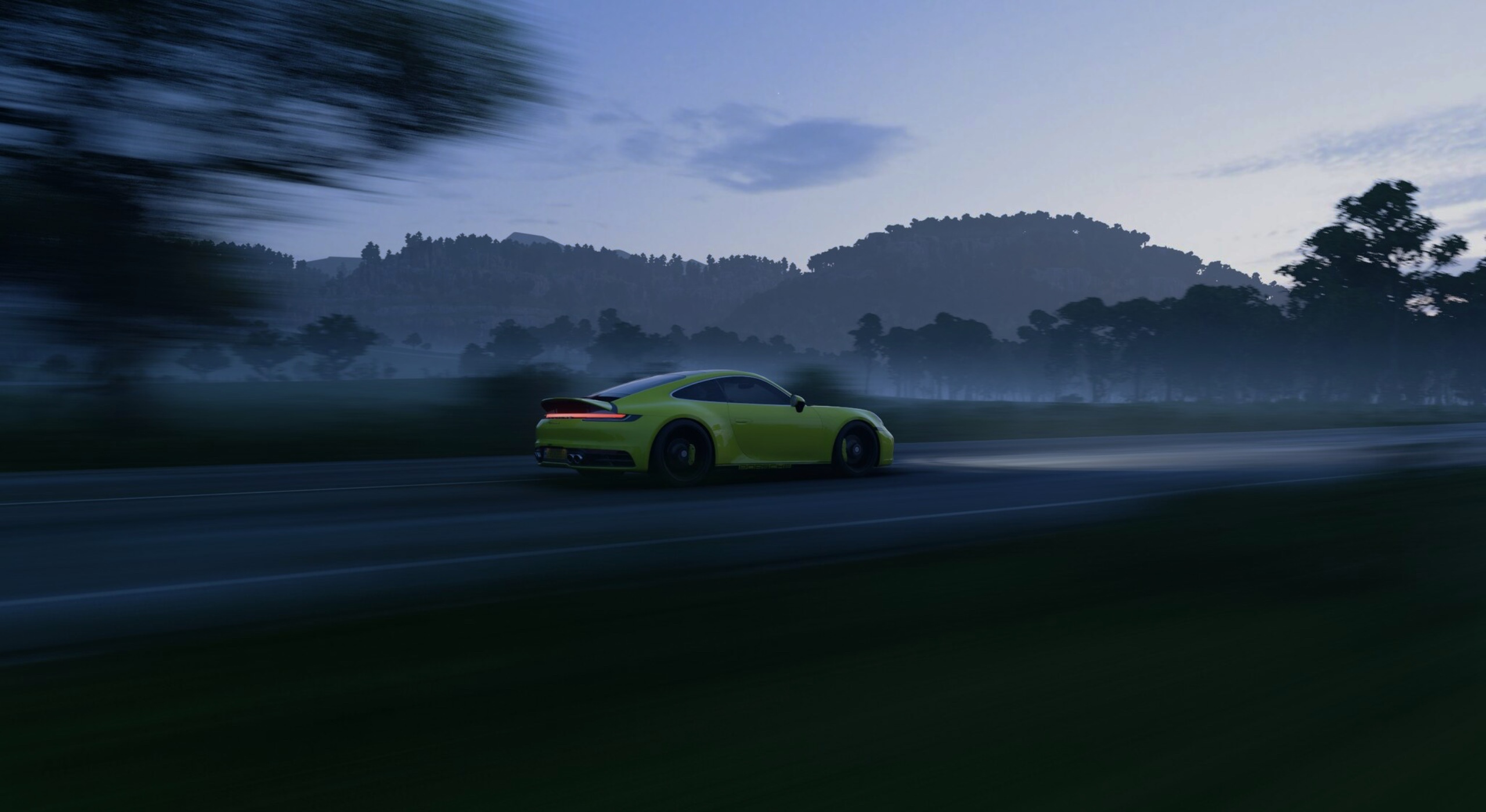 Yellow Porsche 911 driving on a road at dusk HD Wallpaper