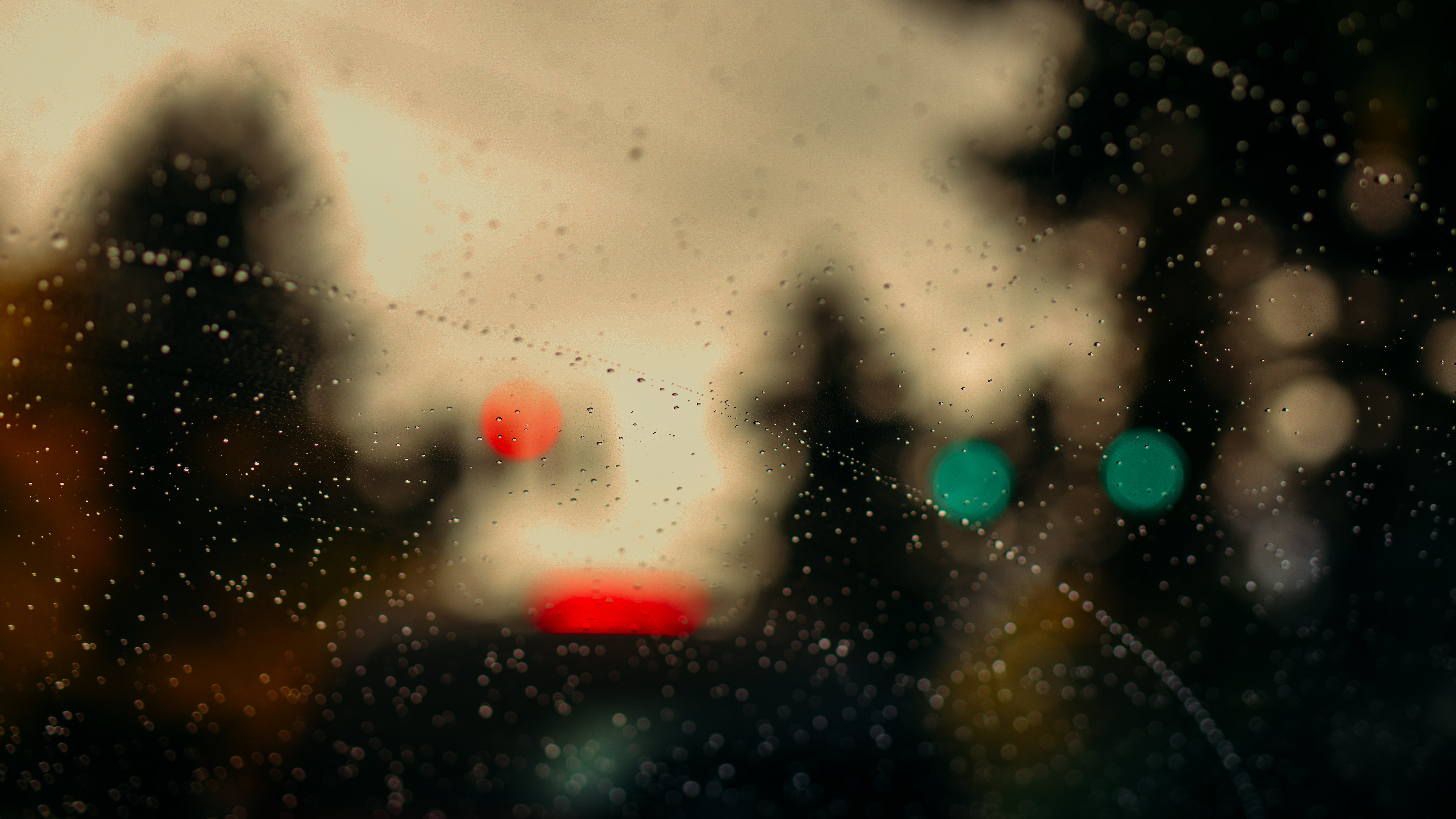 Raindrops on a car windshield with bokeh lights HD Wallpaper