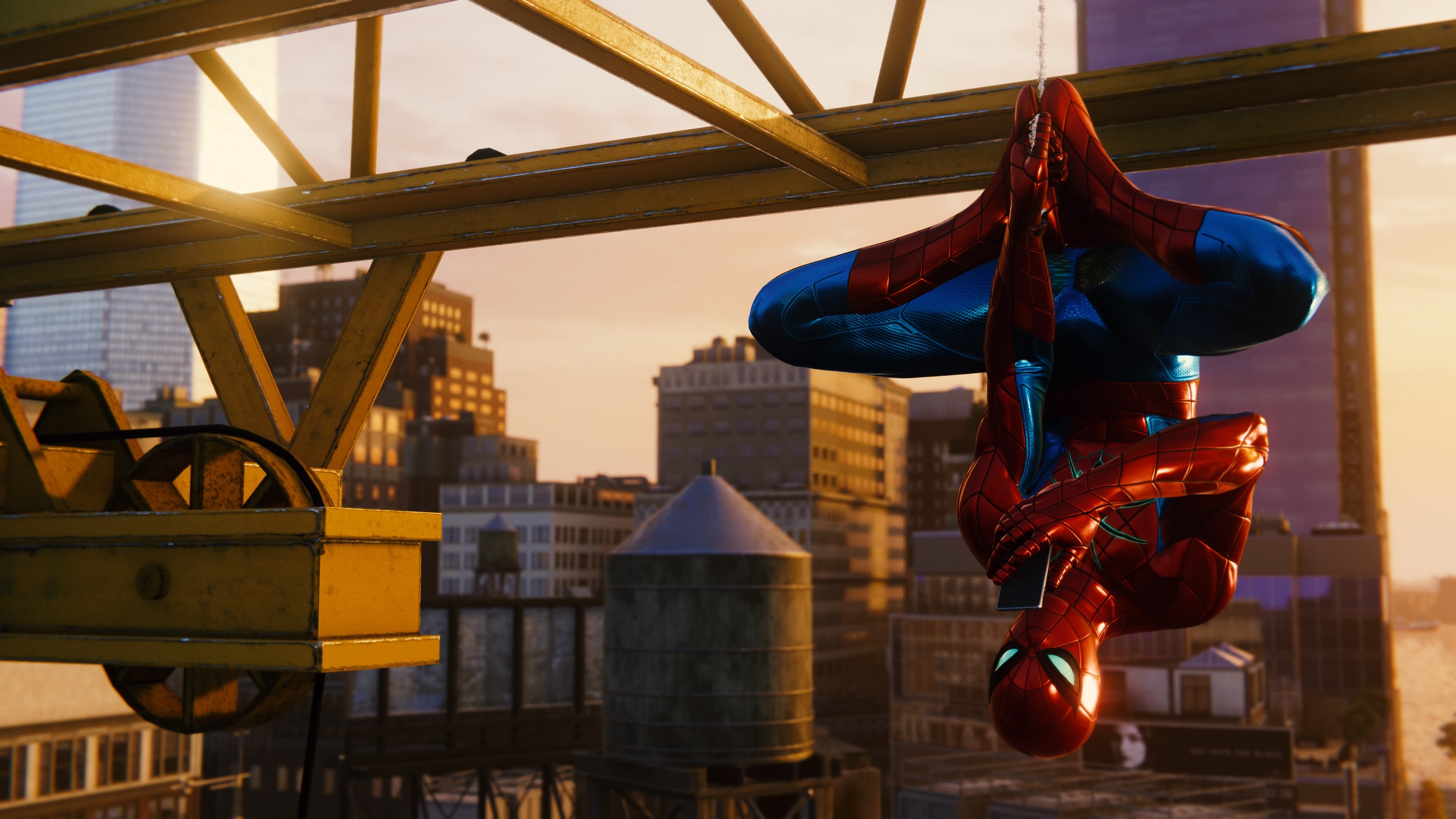 Spider-Man hanging from a crane in a city HD Wallpaper