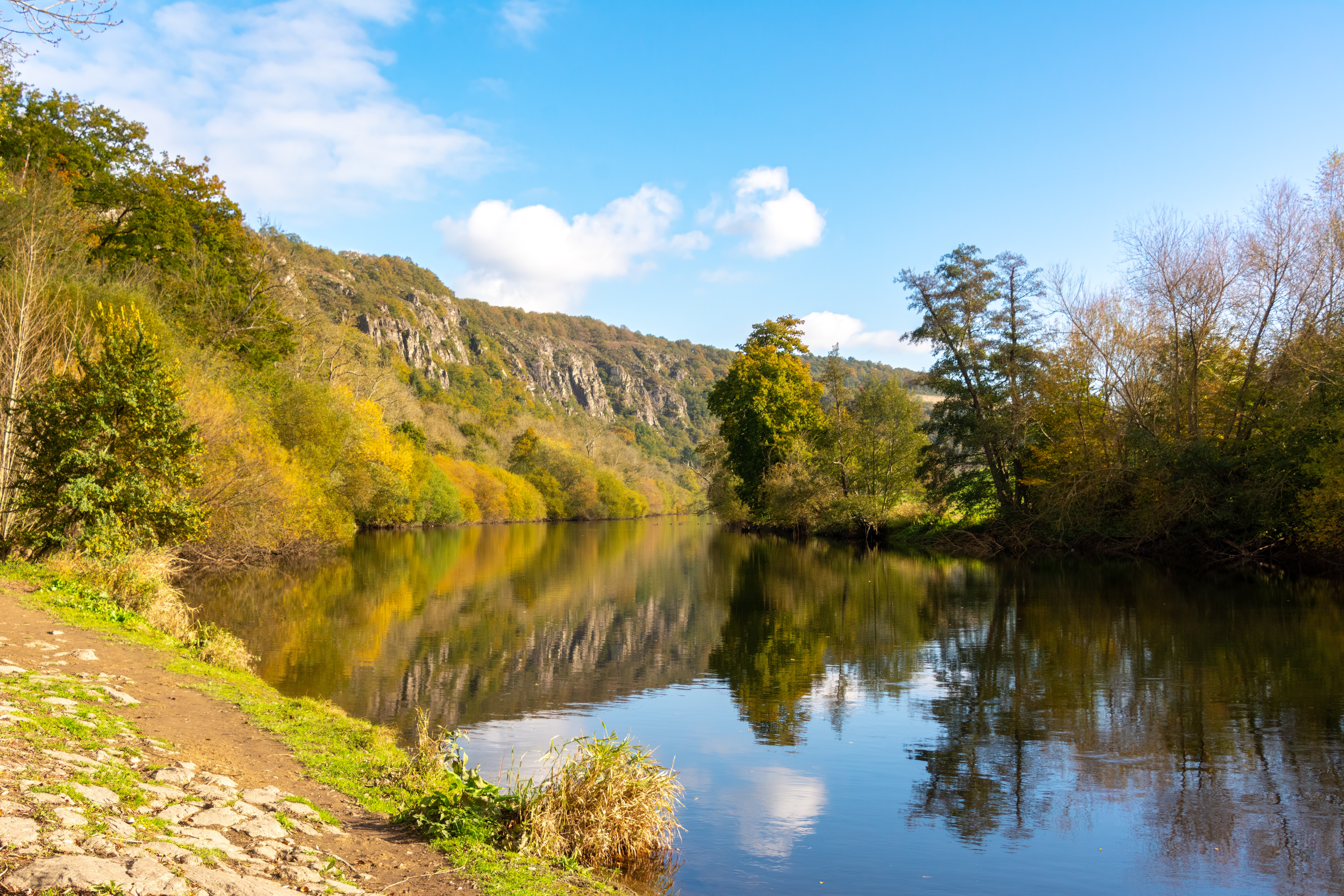 4K river reflection with trees and rocky hills HD Wallpaper