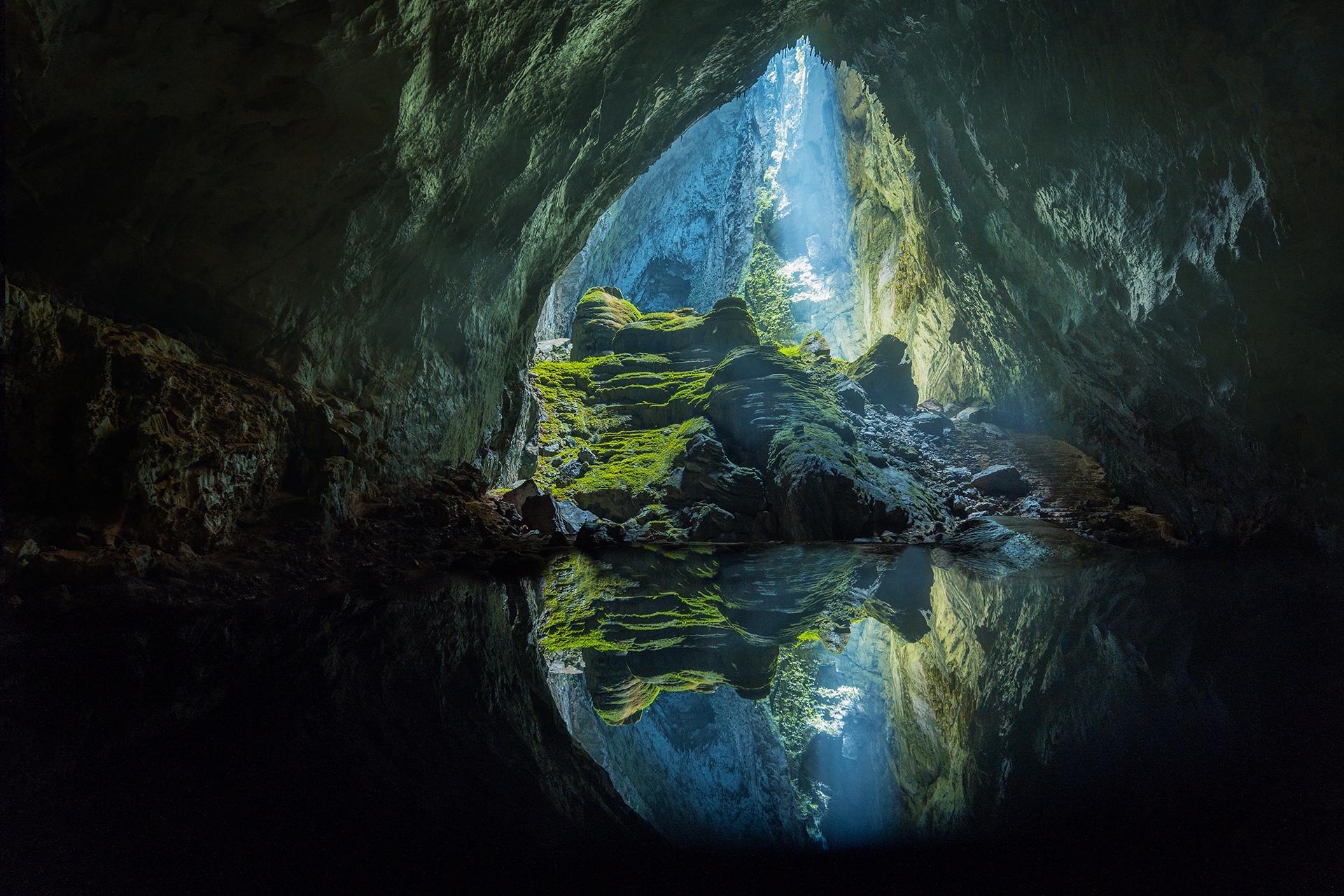 Hang Son Doong cave in Vietnam with mossy rocks and water reflection HD Wallpaper