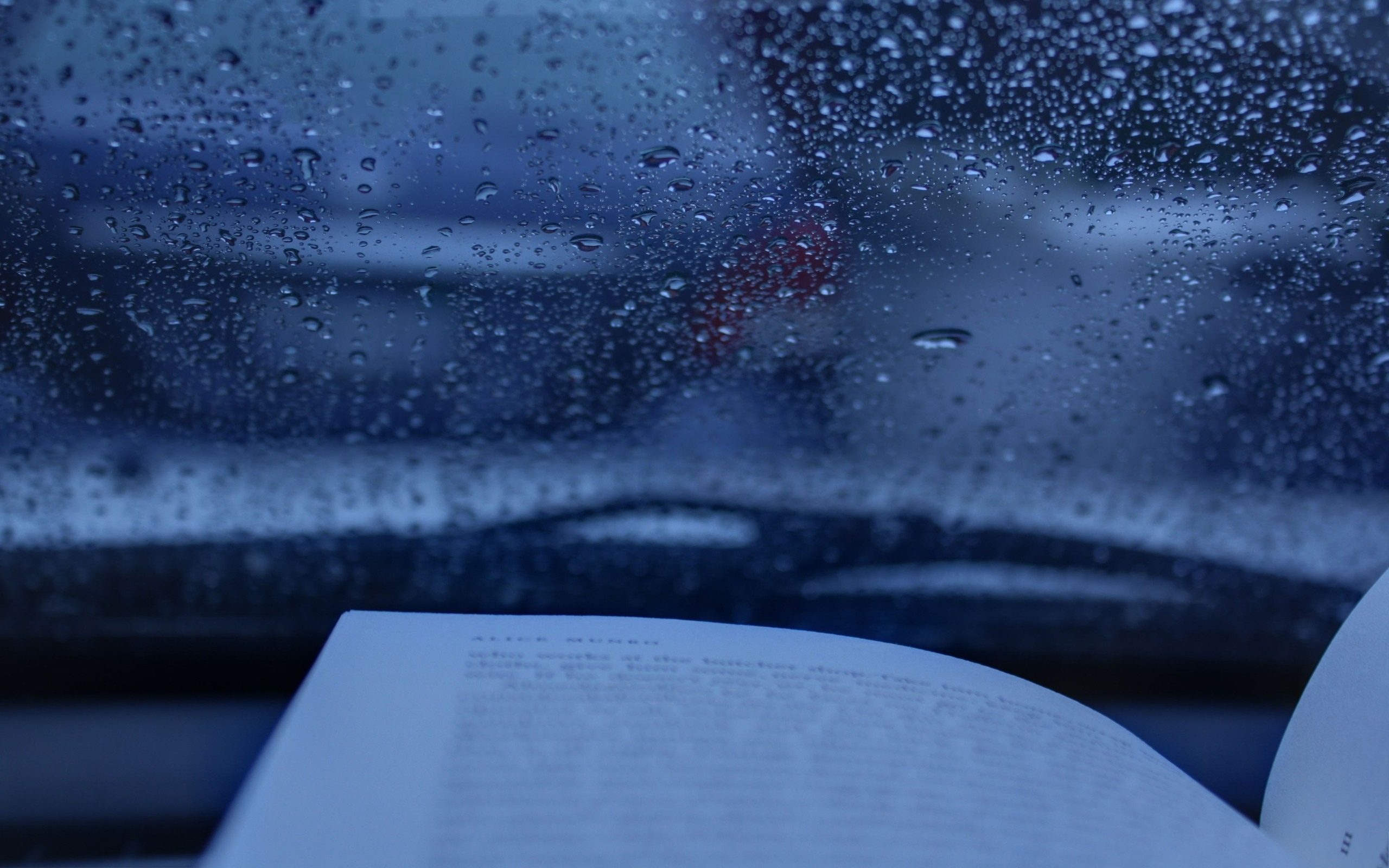 Book on a car dashboard during rain HD Wallpaper