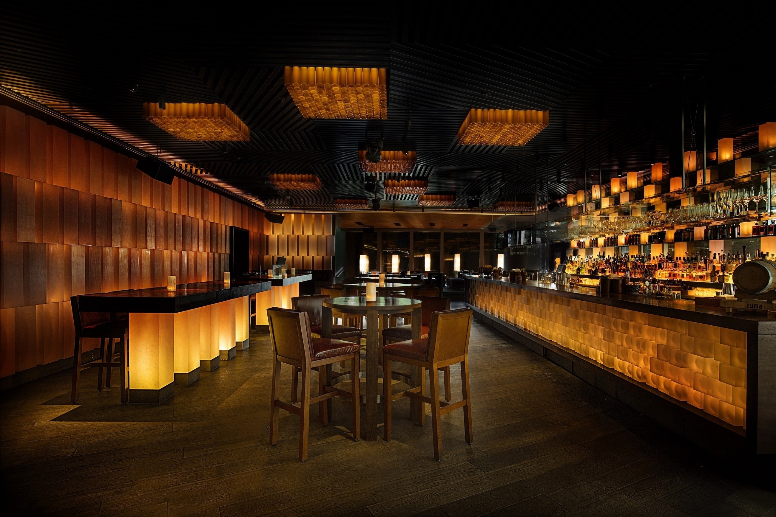 Interior of a modern bar with glowing walls and bottles HD Wallpaper