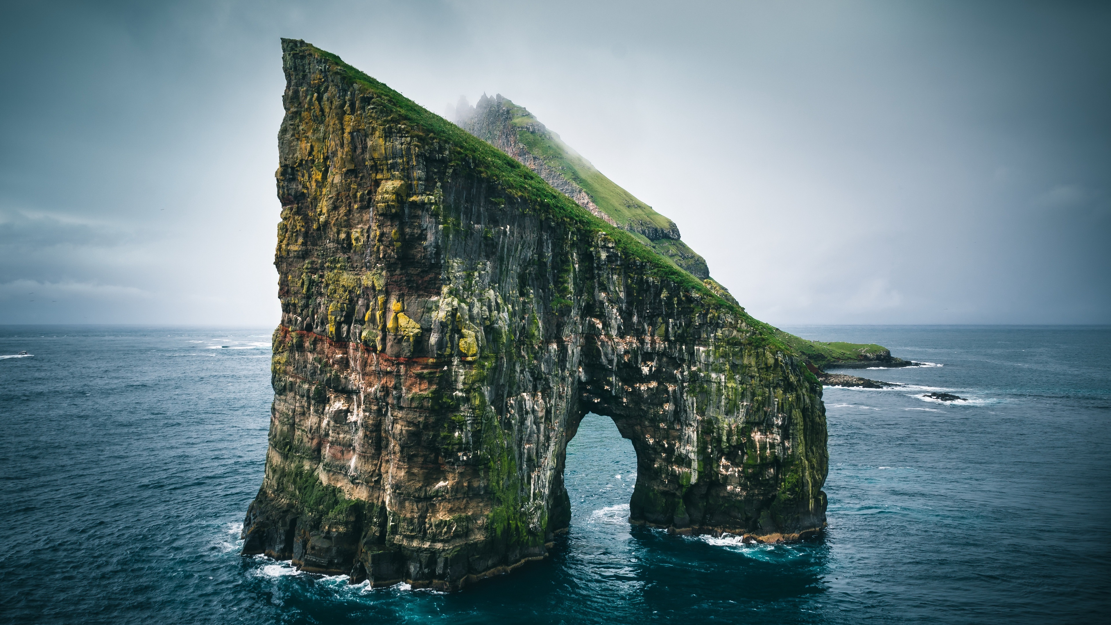 4K rock arch in the sea under a cloudy sky HD Wallpaper