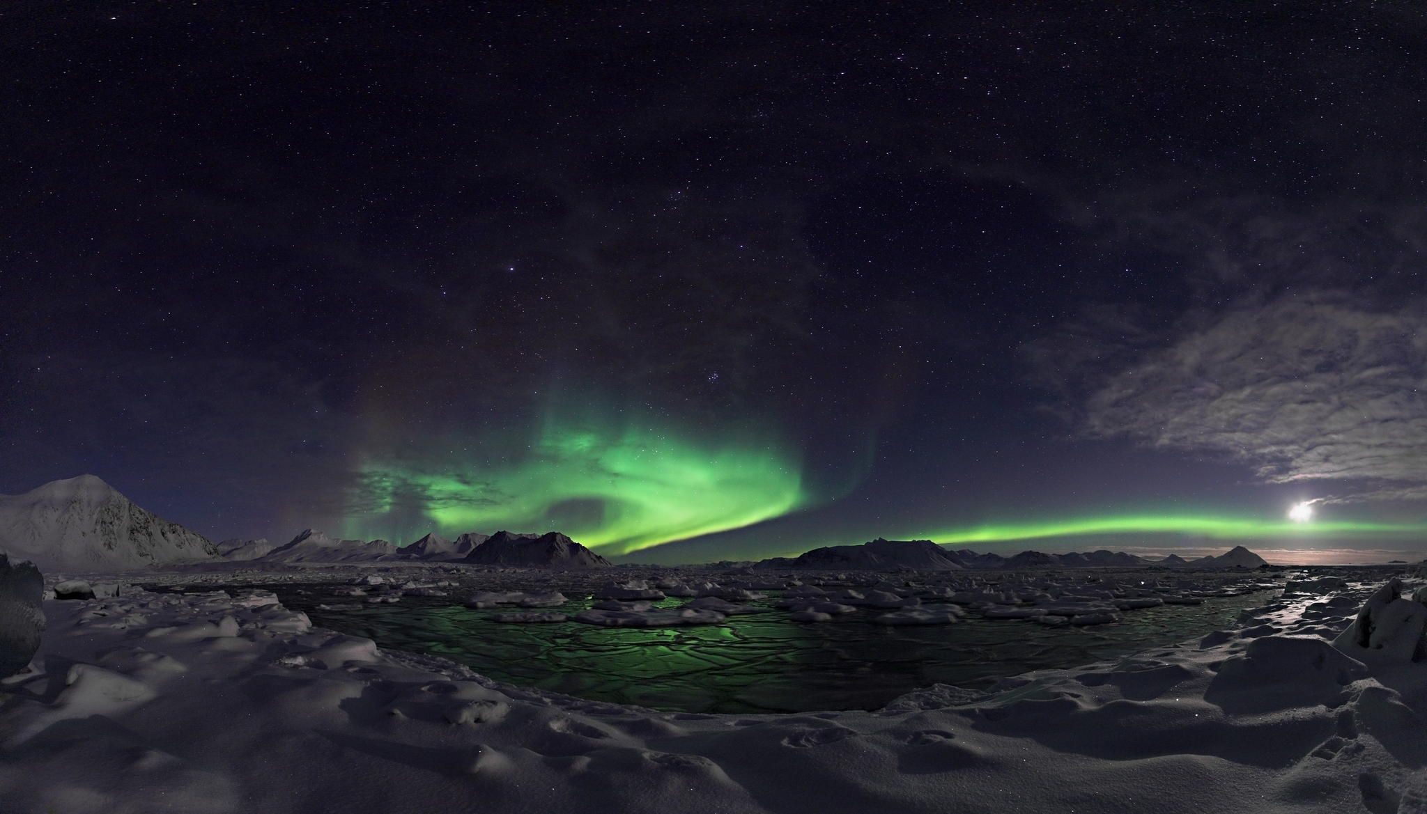 Aurora Borealis over a snowy Icelandic landscape at night HD Wallpaper