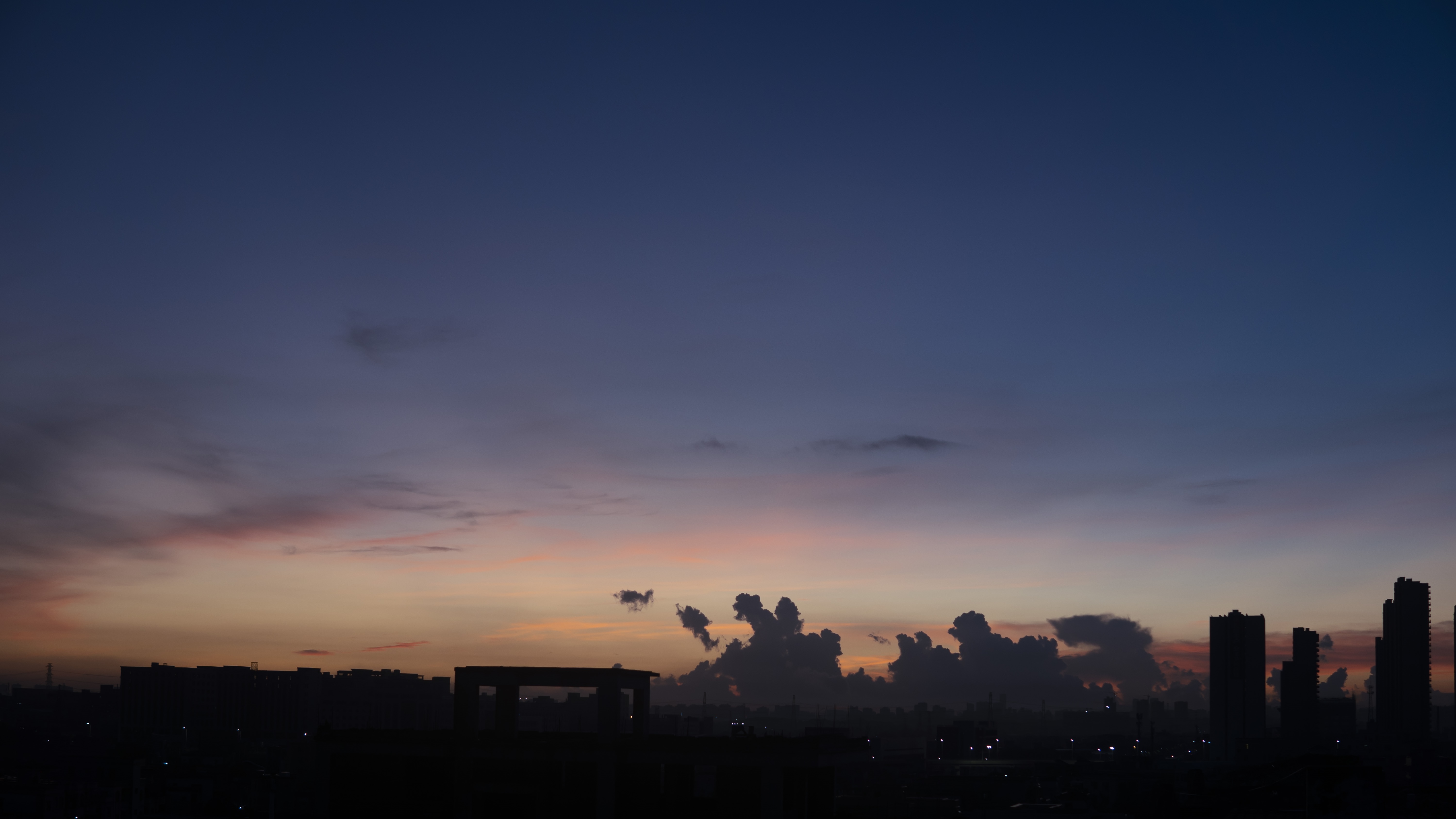 Cityscape at dusk with colorful clouds HD Wallpaper