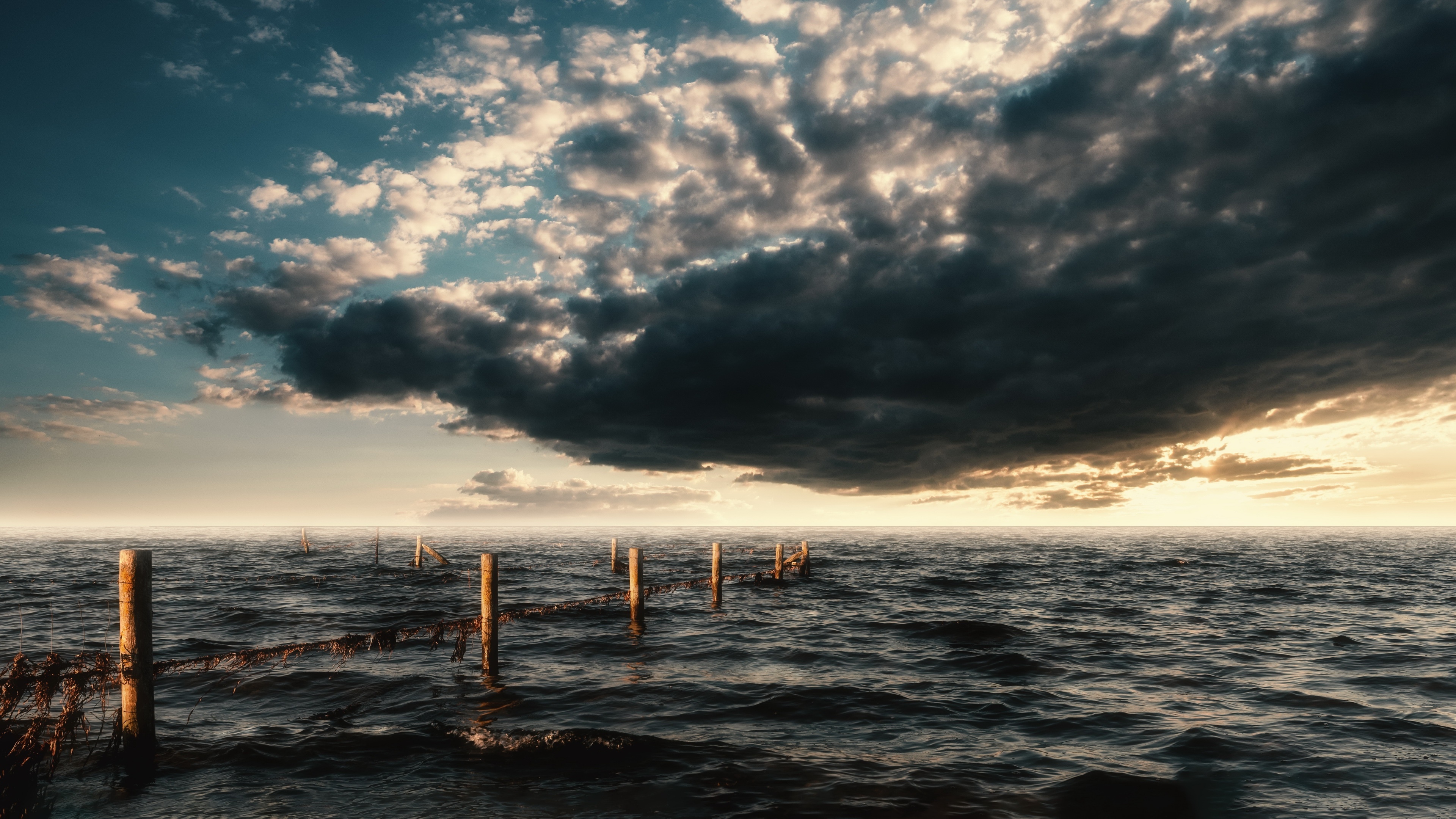 4K Dark Sea with Stormy Clouds and Sunlight HD Wallpaper