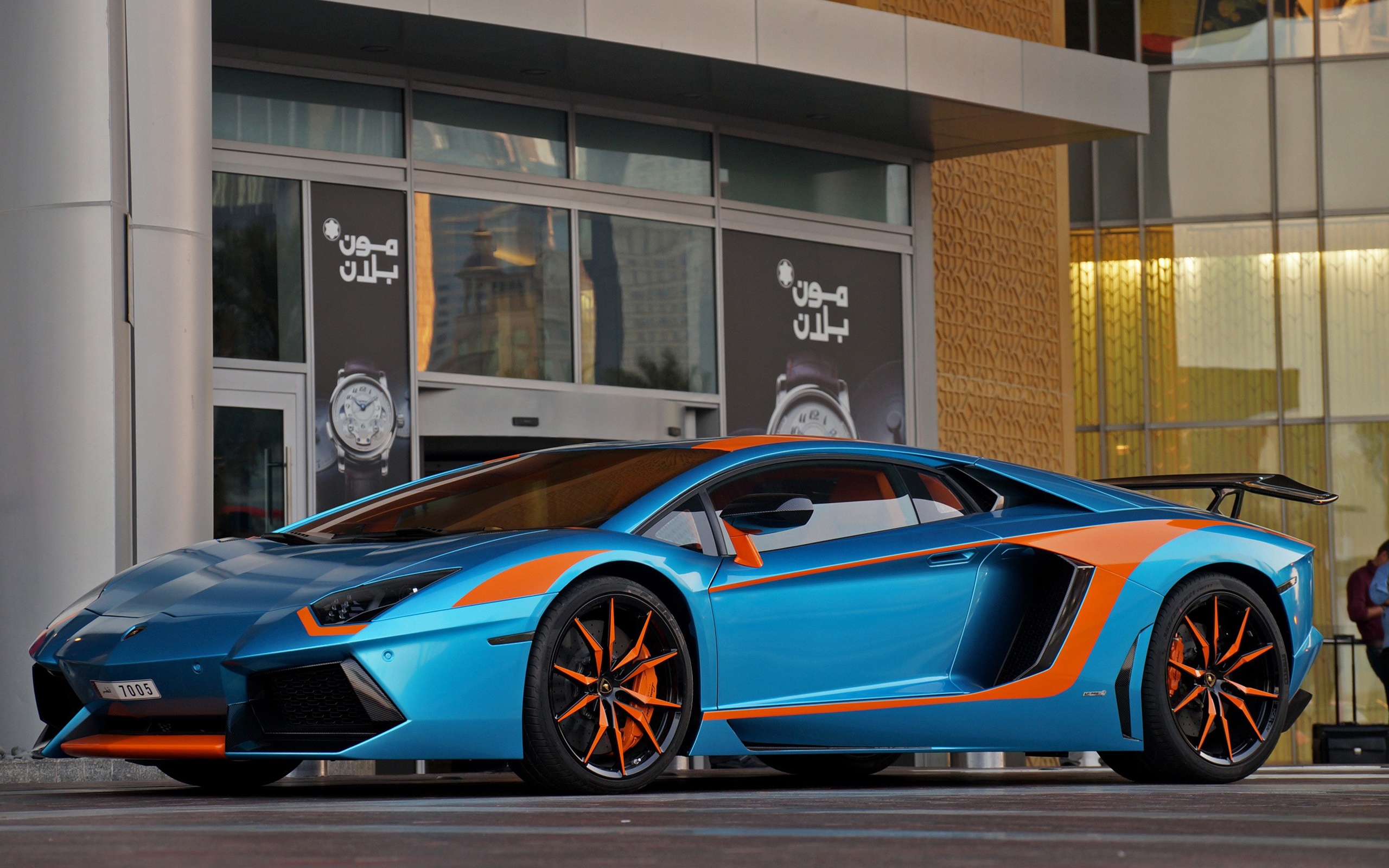 Blue and orange Lamborghini Aventador parked outside building HD Wallpaper