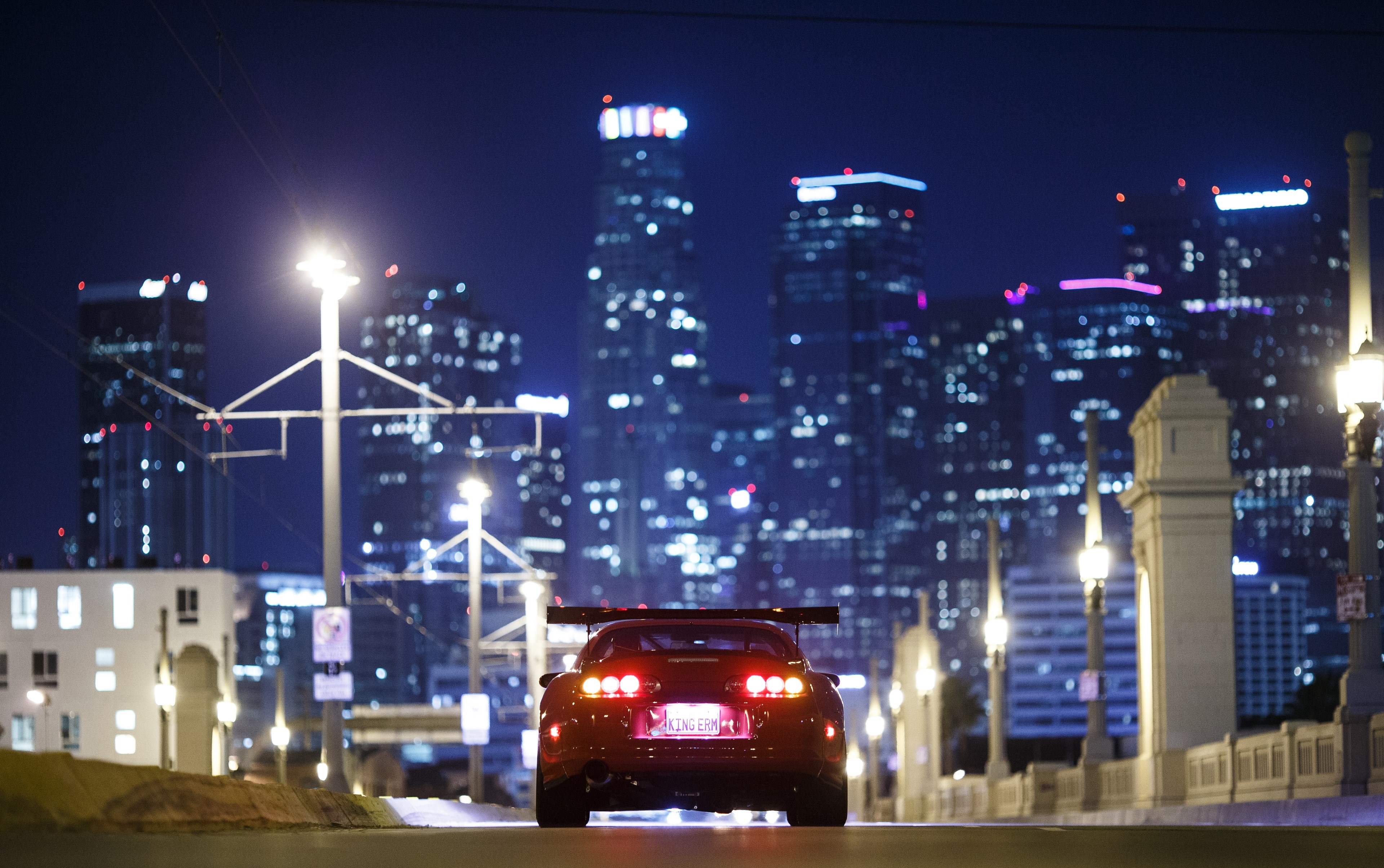 4K Toyota Supra A80 at night with city lights HD Wallpaper