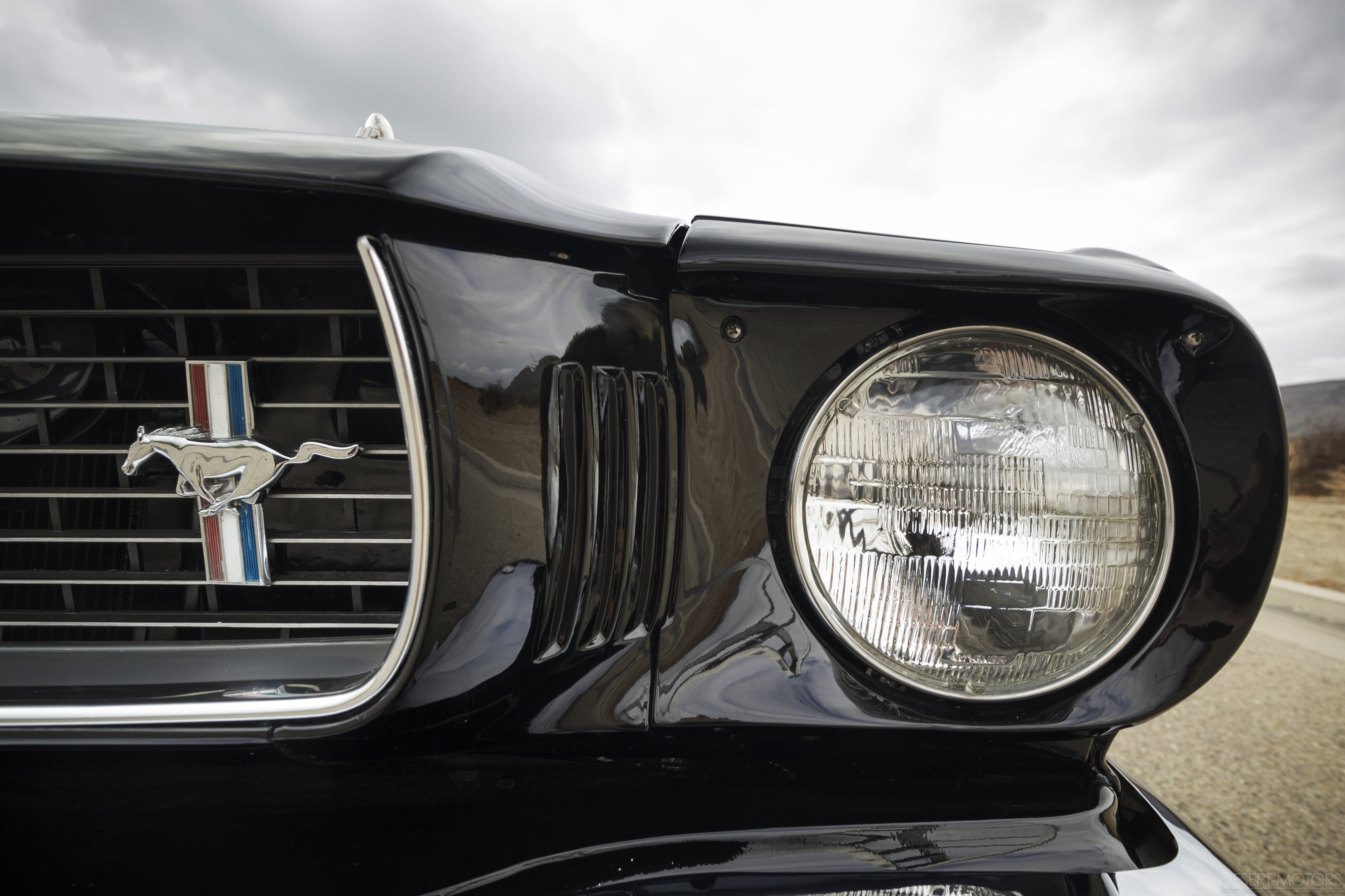 4K Close-up of a Black Ford Mustang Grille and Headlight HD Wallpaper