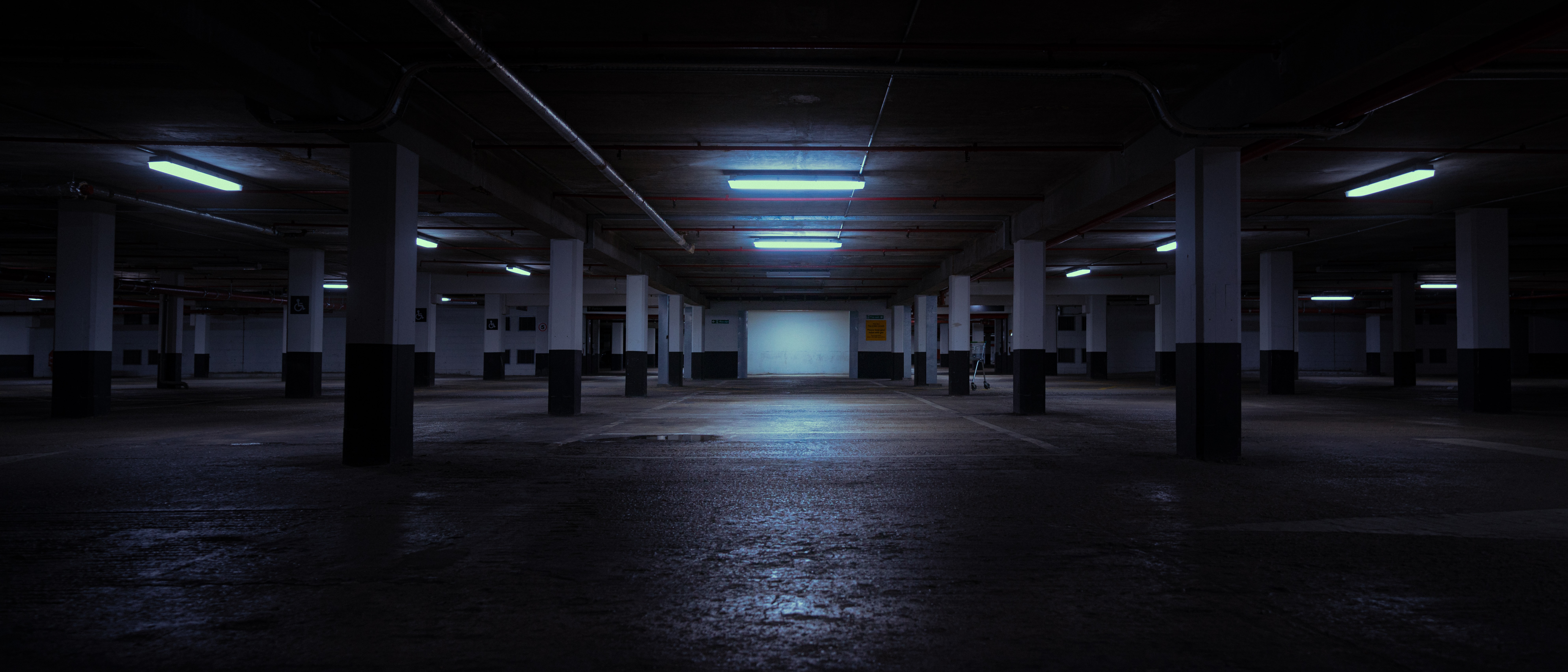 Dark urban parking garage at night HD Wallpaper