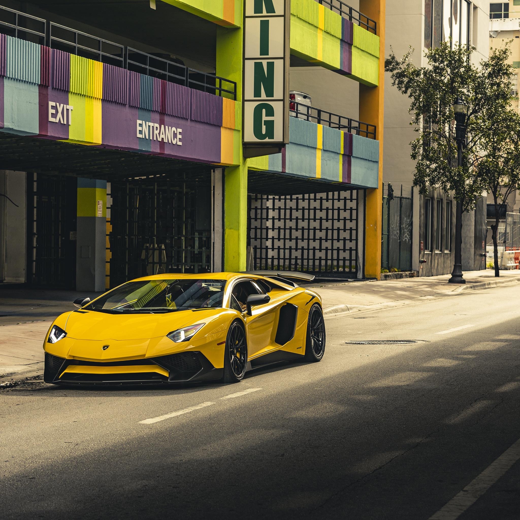 Yellow Lamborghini Aventador parked on a street HD Wallpaper