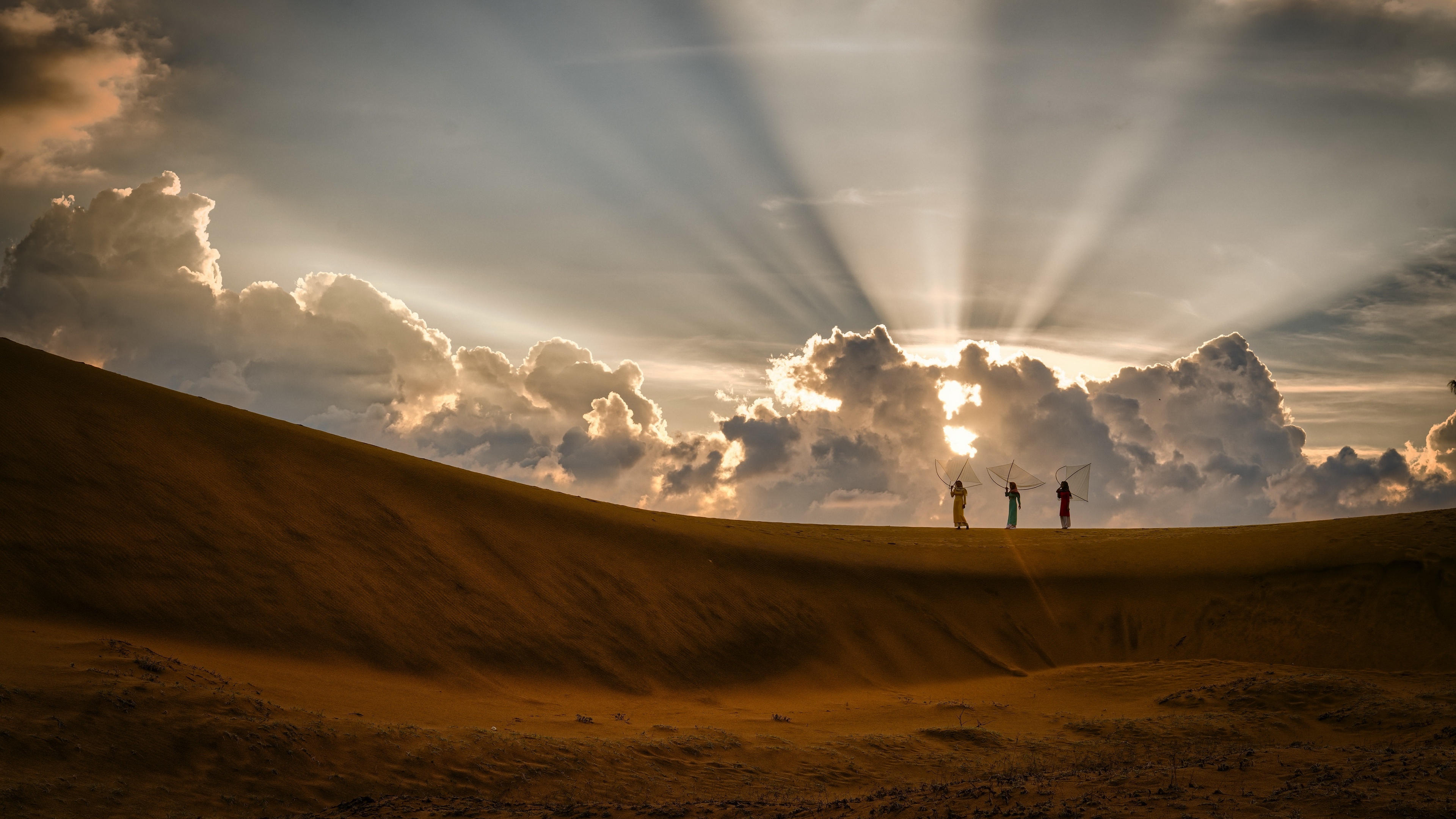 Four women with fishing nets on a sand dune at sunset HD Wallpaper