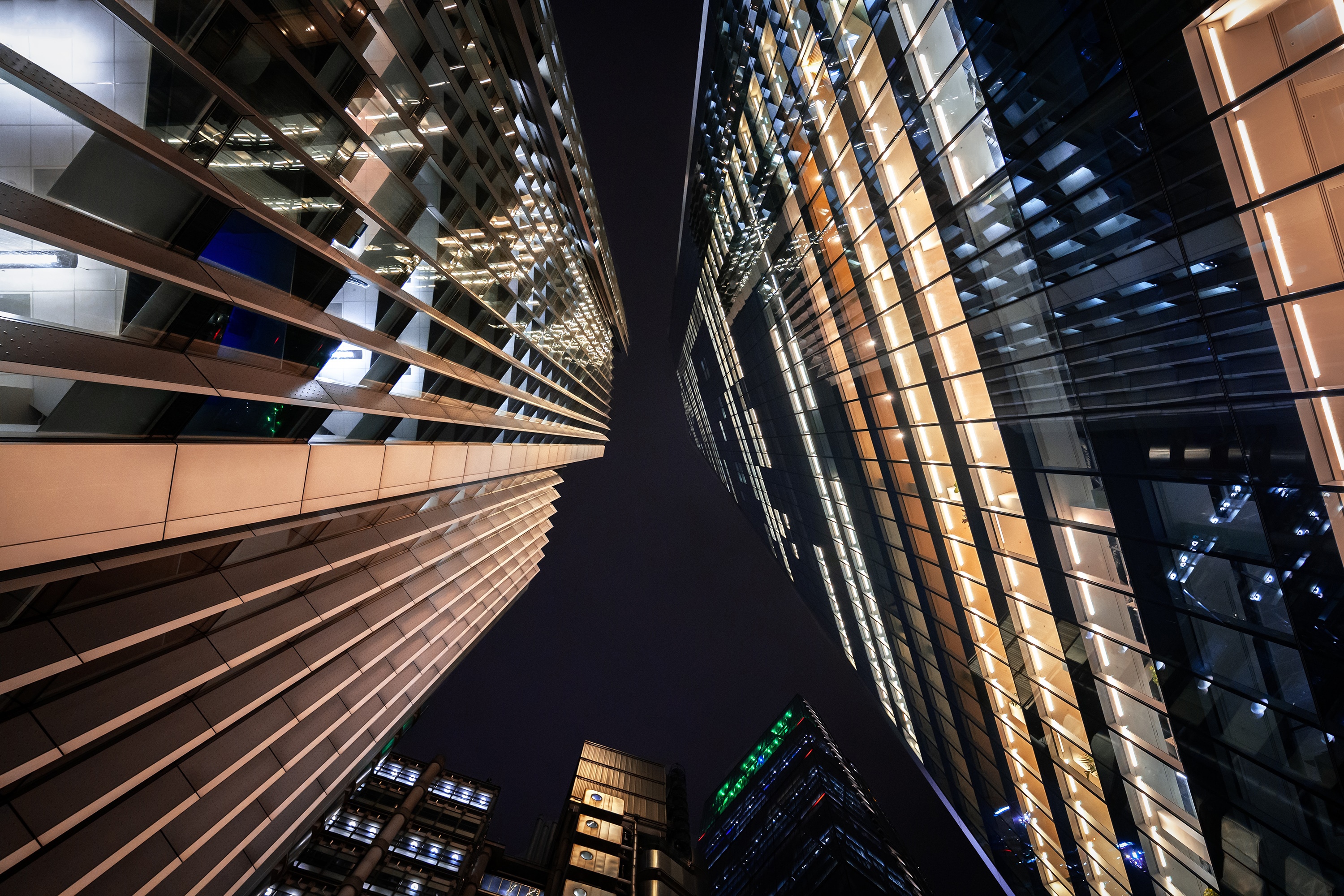 Modern skyscrapers at night with illuminated windows HD Wallpaper