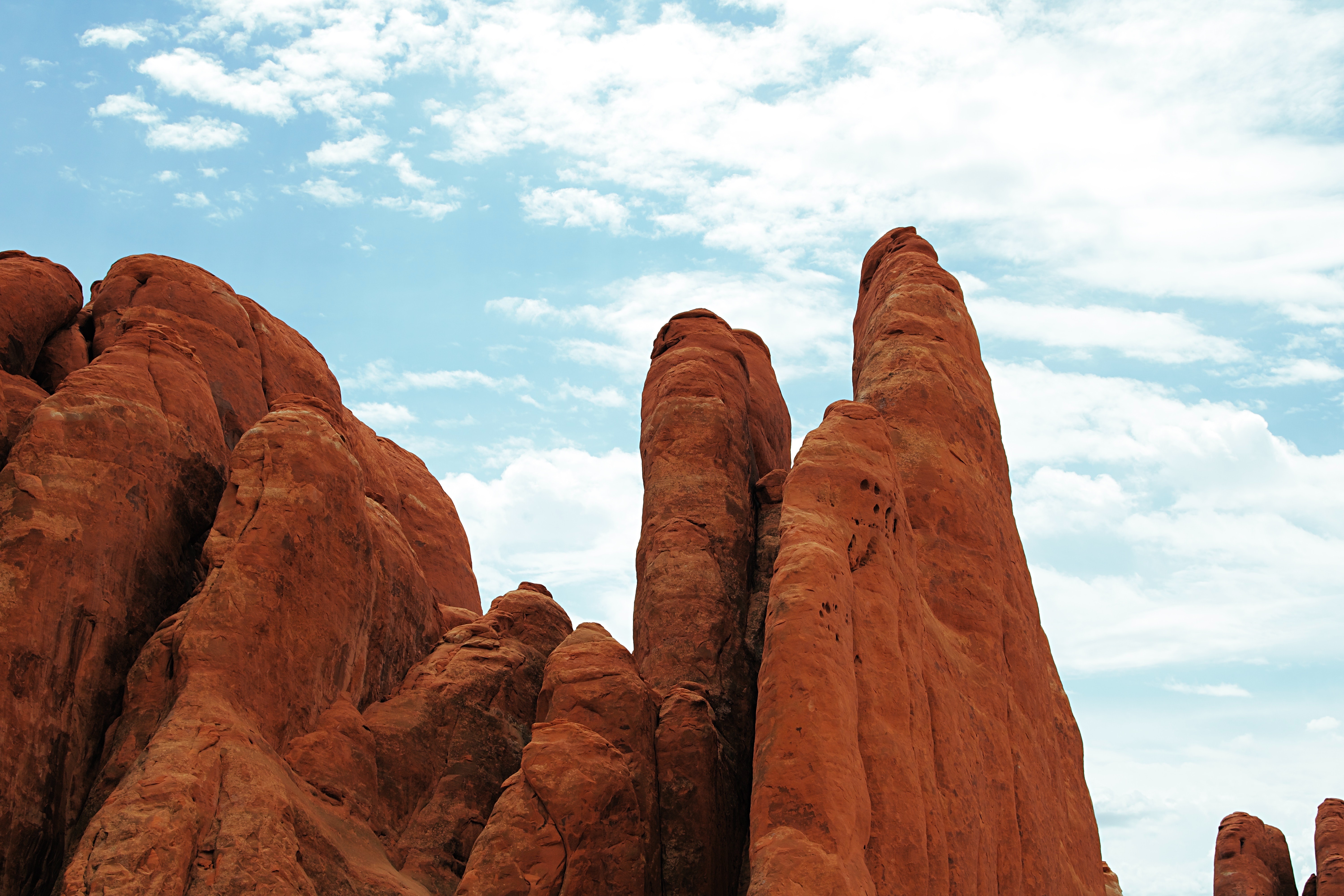 Arches National Park rock formations under a cloudy sky HD Wallpaper