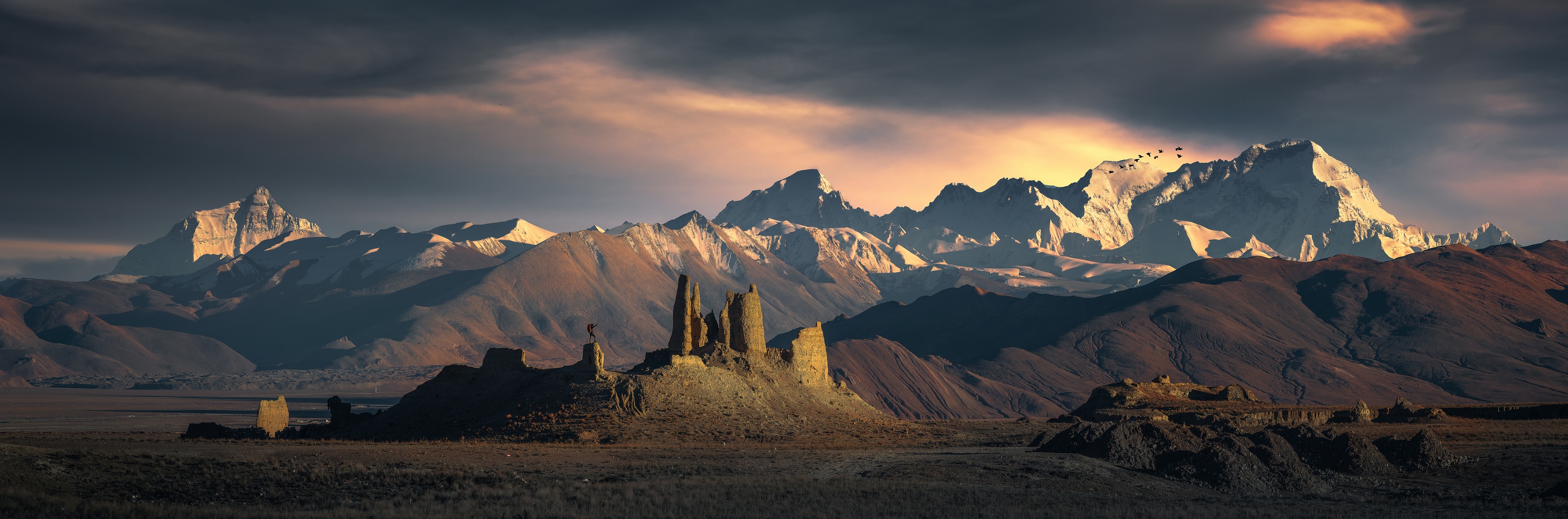Panoramic view of snow-capped mountains and rock formations HD Wallpaper