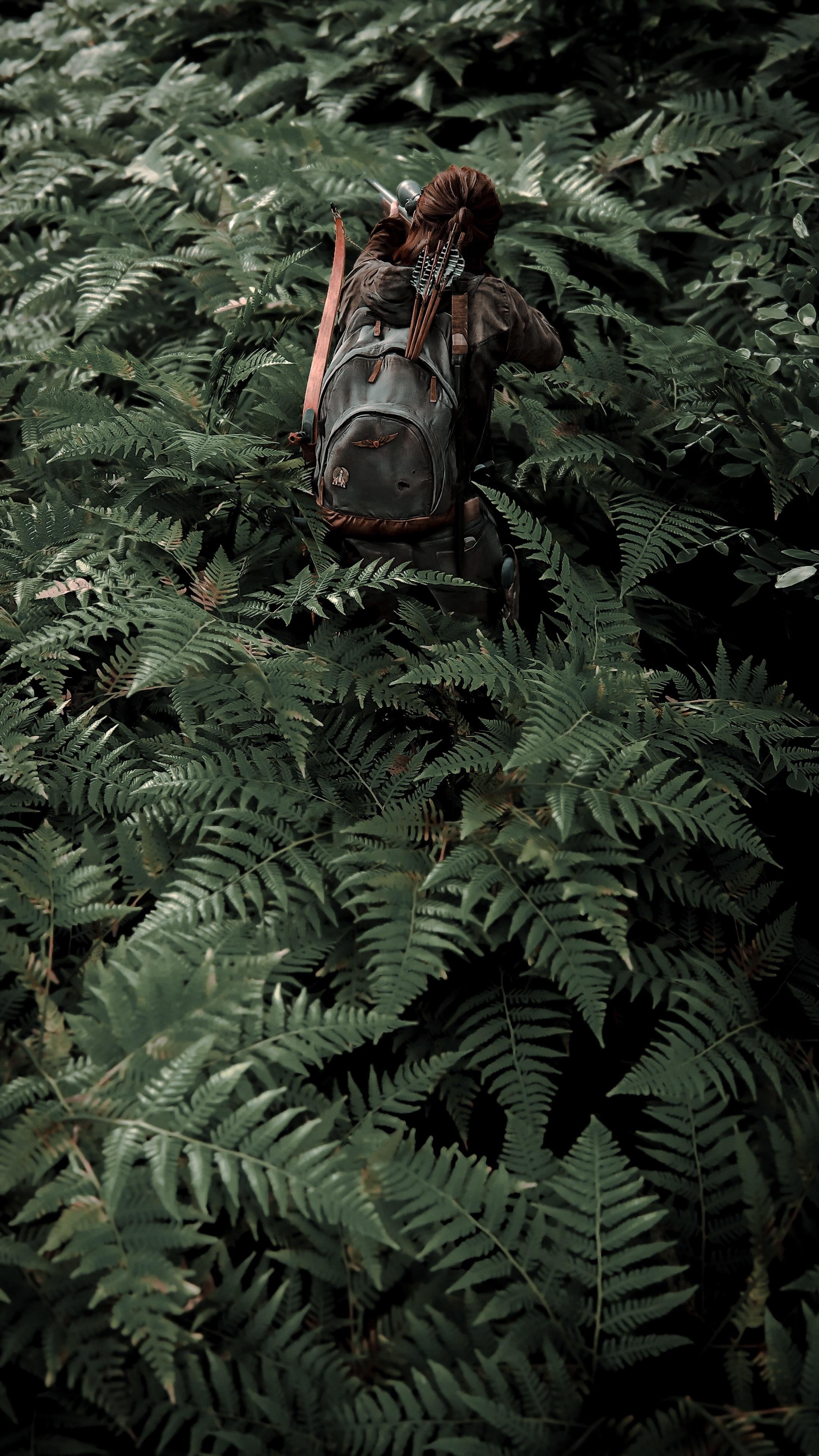 Ellie Williams with a bow and arrows in a forest HD Phone Wallpaper