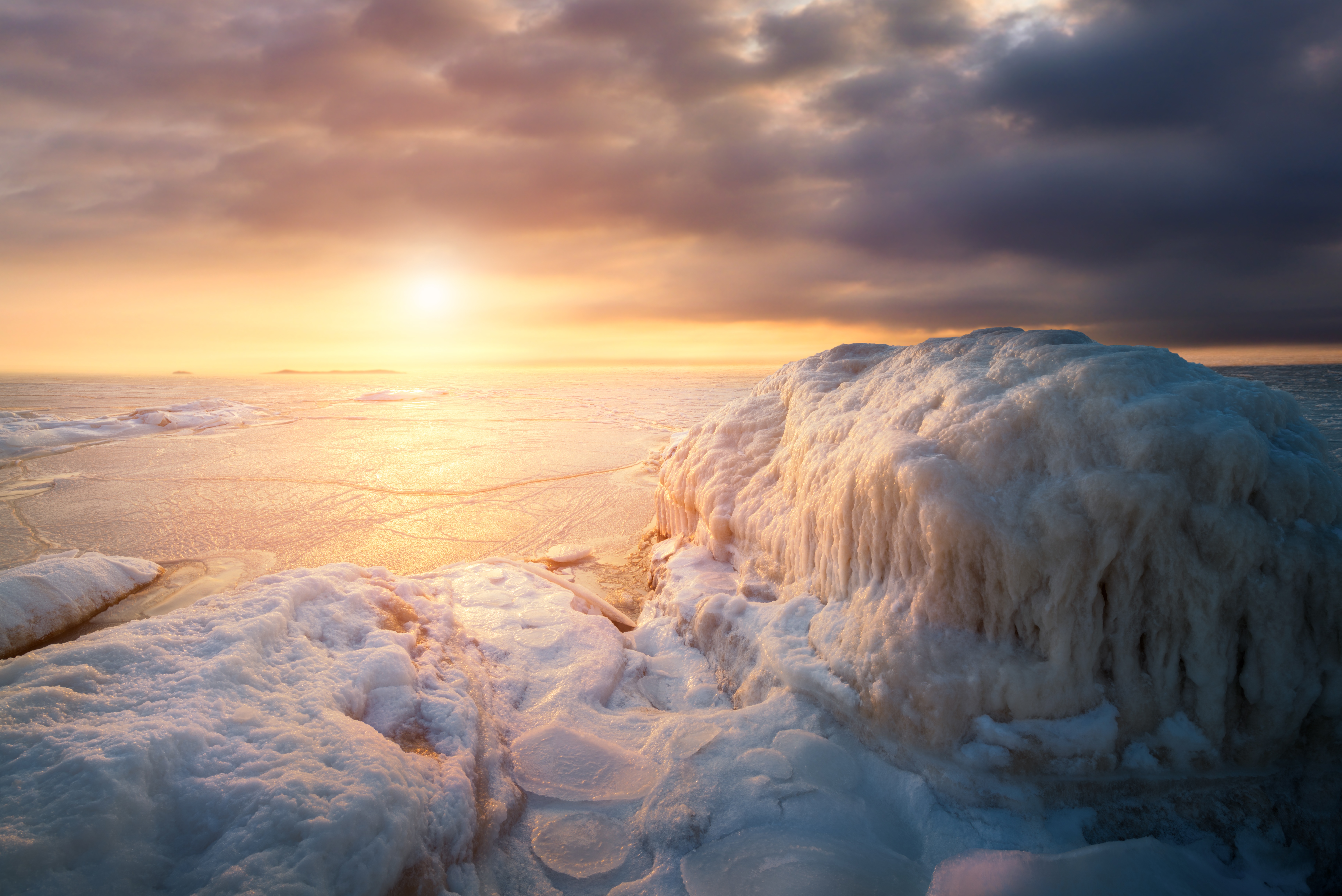 Frozen landscape at sunset with dramatic clouds HD Wallpaper