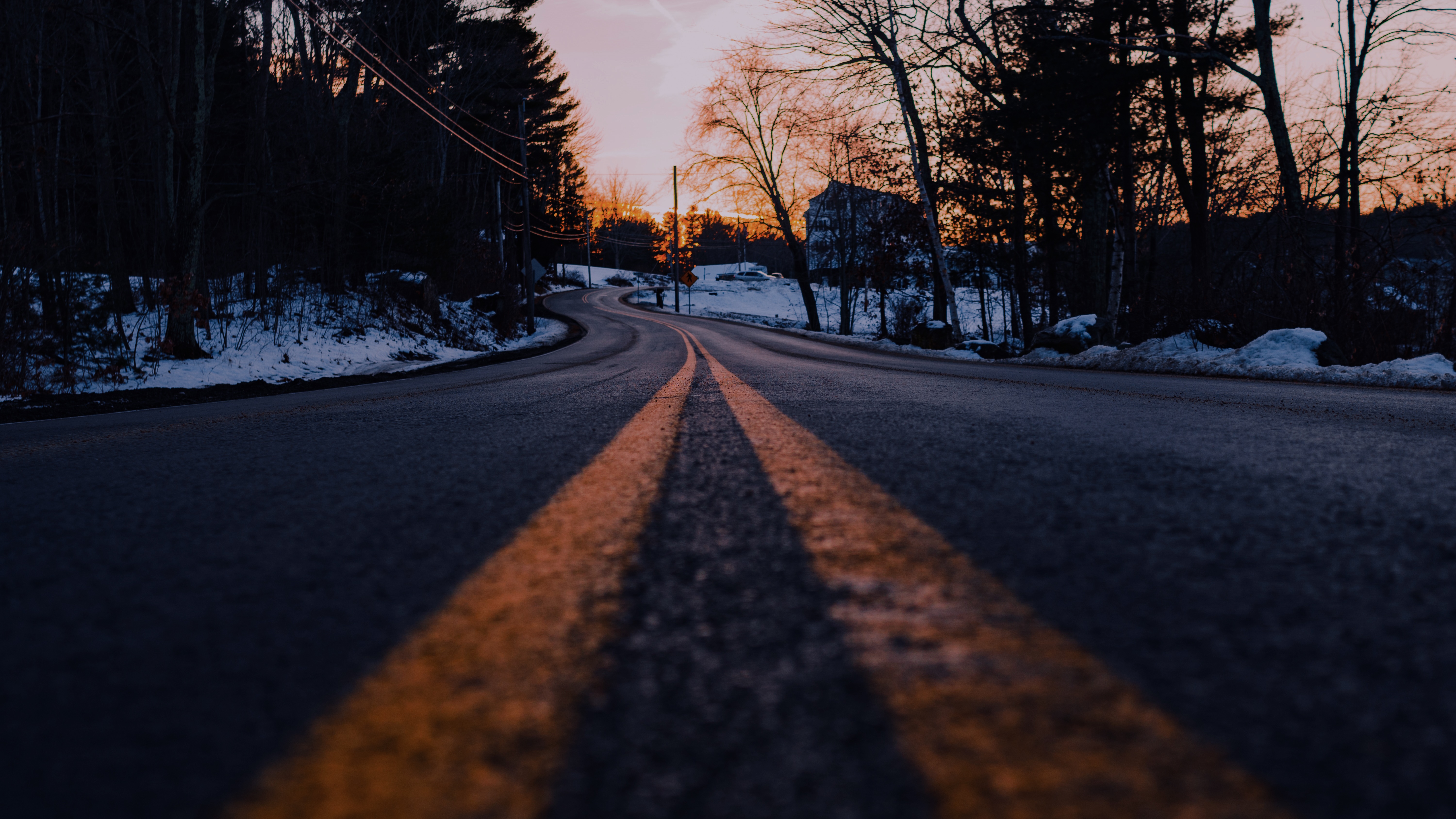 Road with double yellow lines at dusk with snow HD Wallpaper