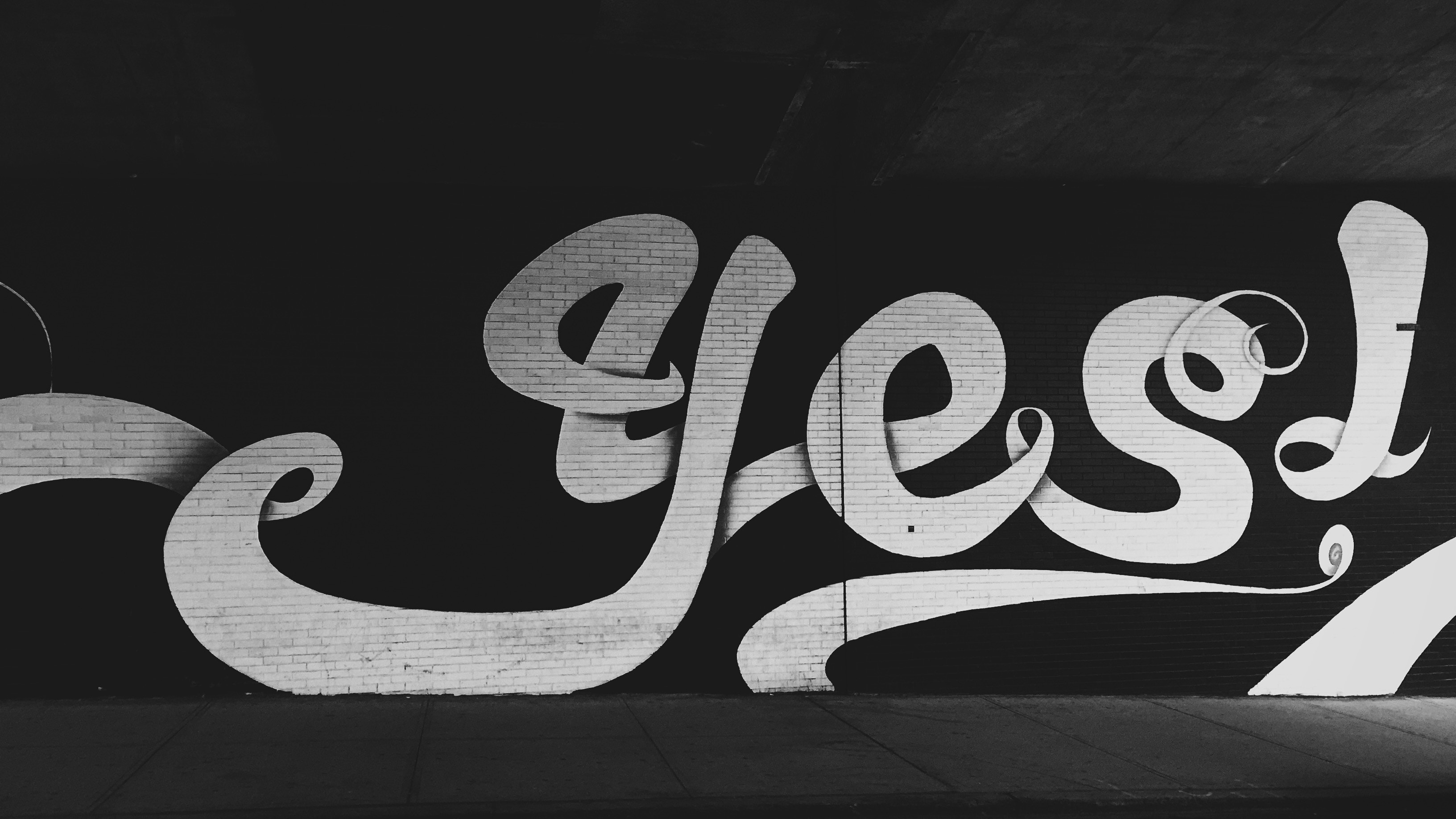 Graffiti text "yes!" on a brick wall HD Wallpaper