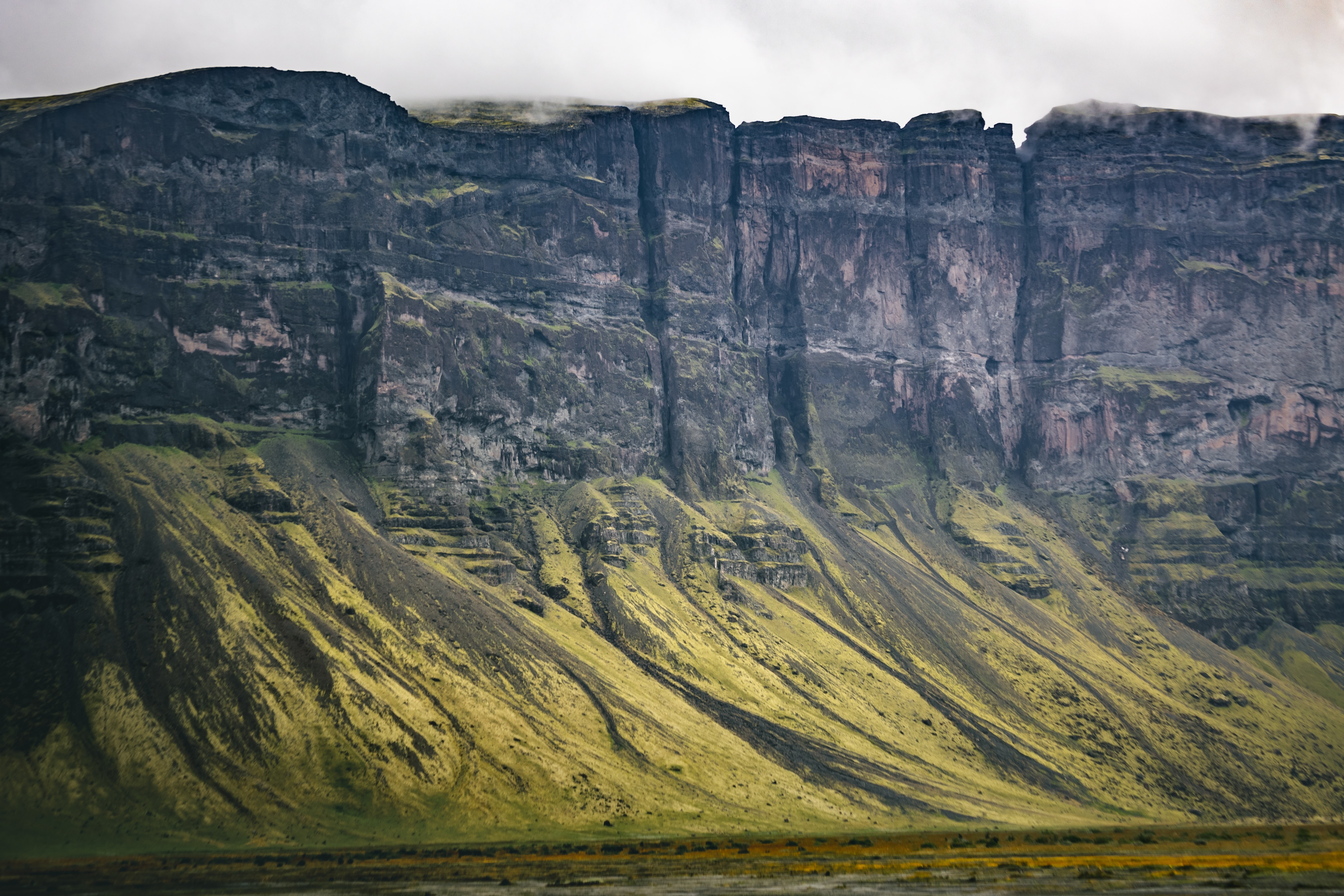 4K Iceland Landscape of Rocky Cliffs and Green Slopes HD Wallpaper