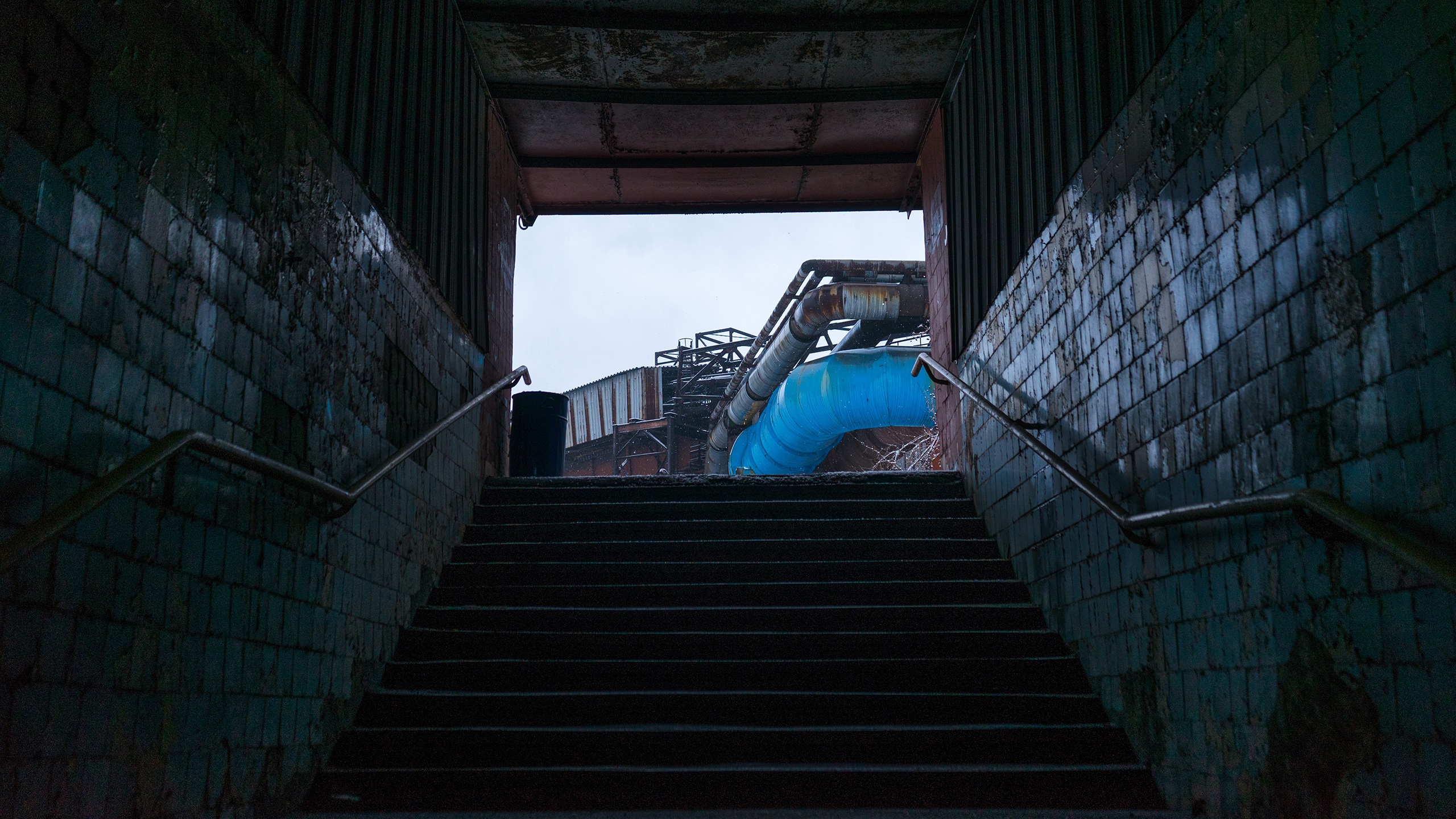 Industrial staircase with blue pipes HD Wallpaper