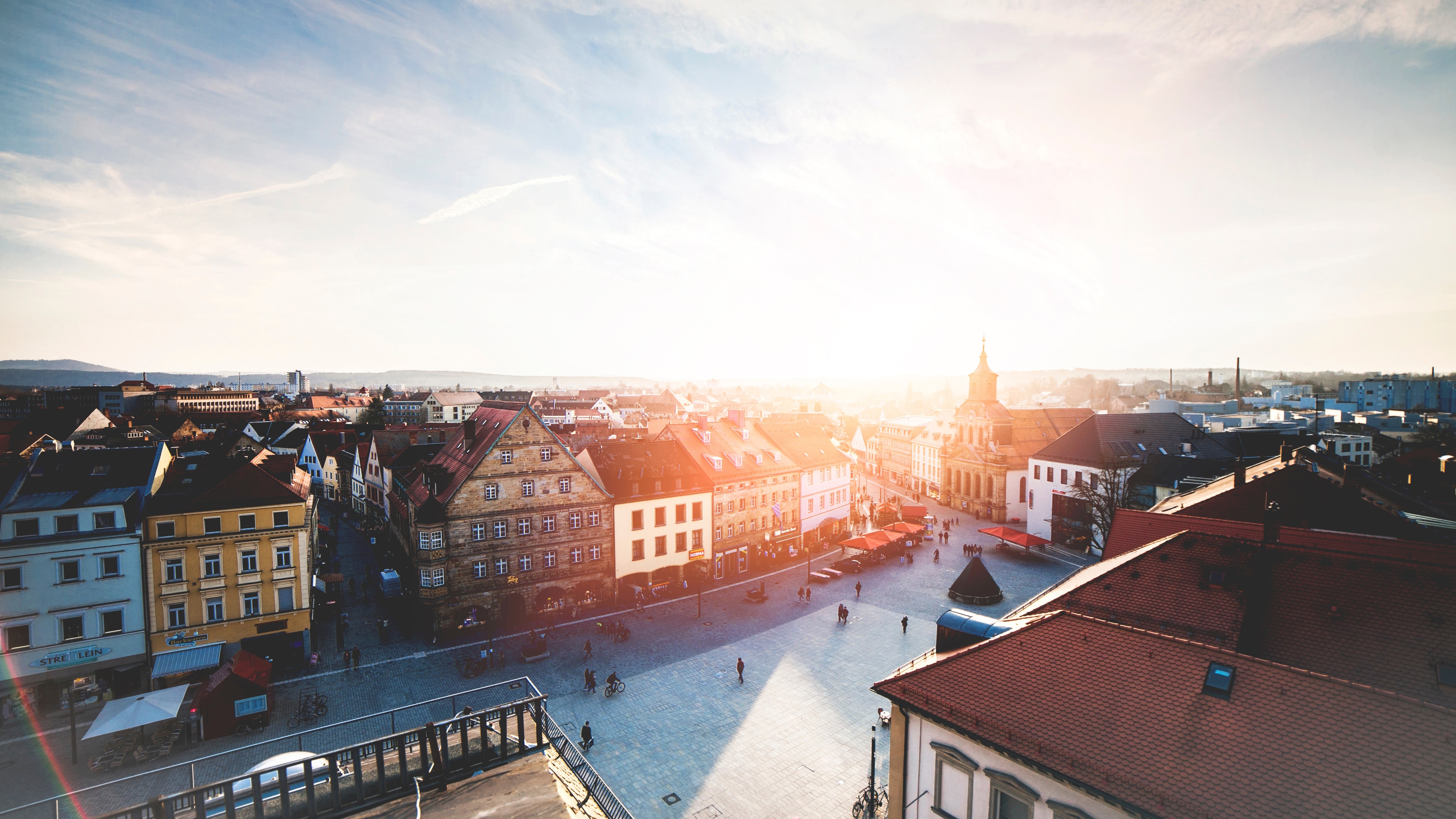 Aerial view of a German town square at sunset HD Wallpaper