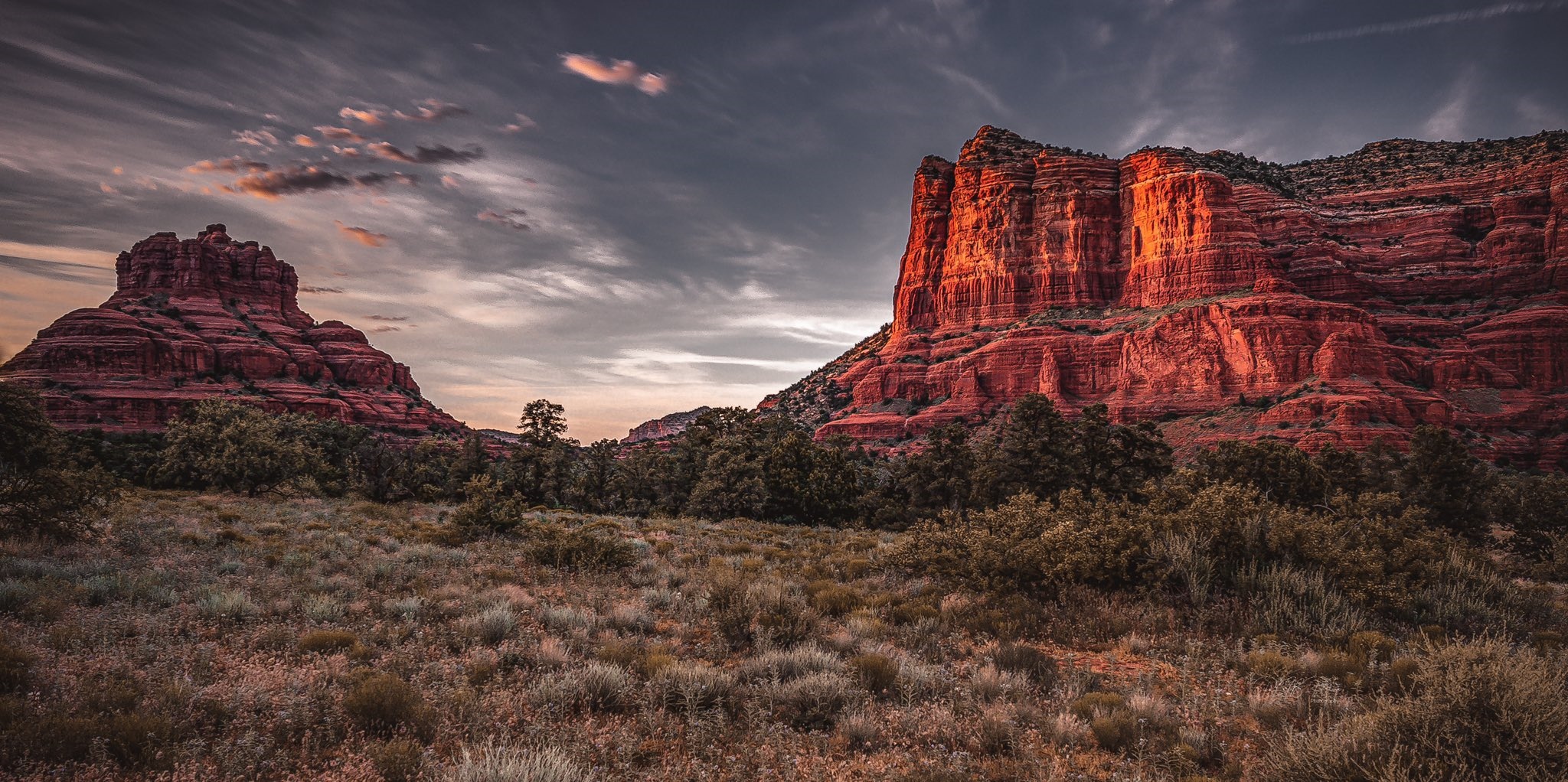 Red rock formations and desert landscape at sunset HD Wallpaper