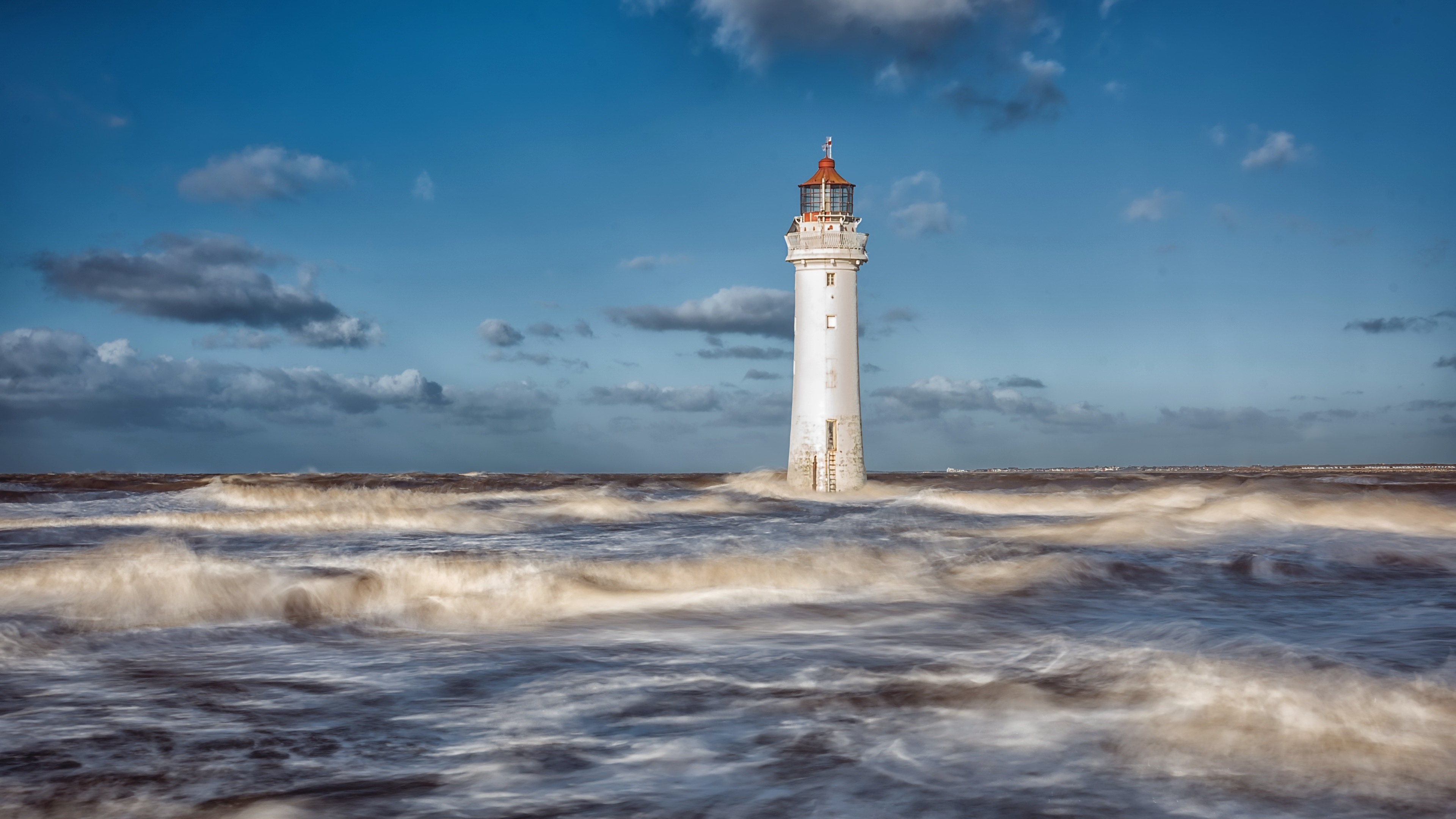 4K lighthouse in rough seas under a cloudy sky HD Wallpaper