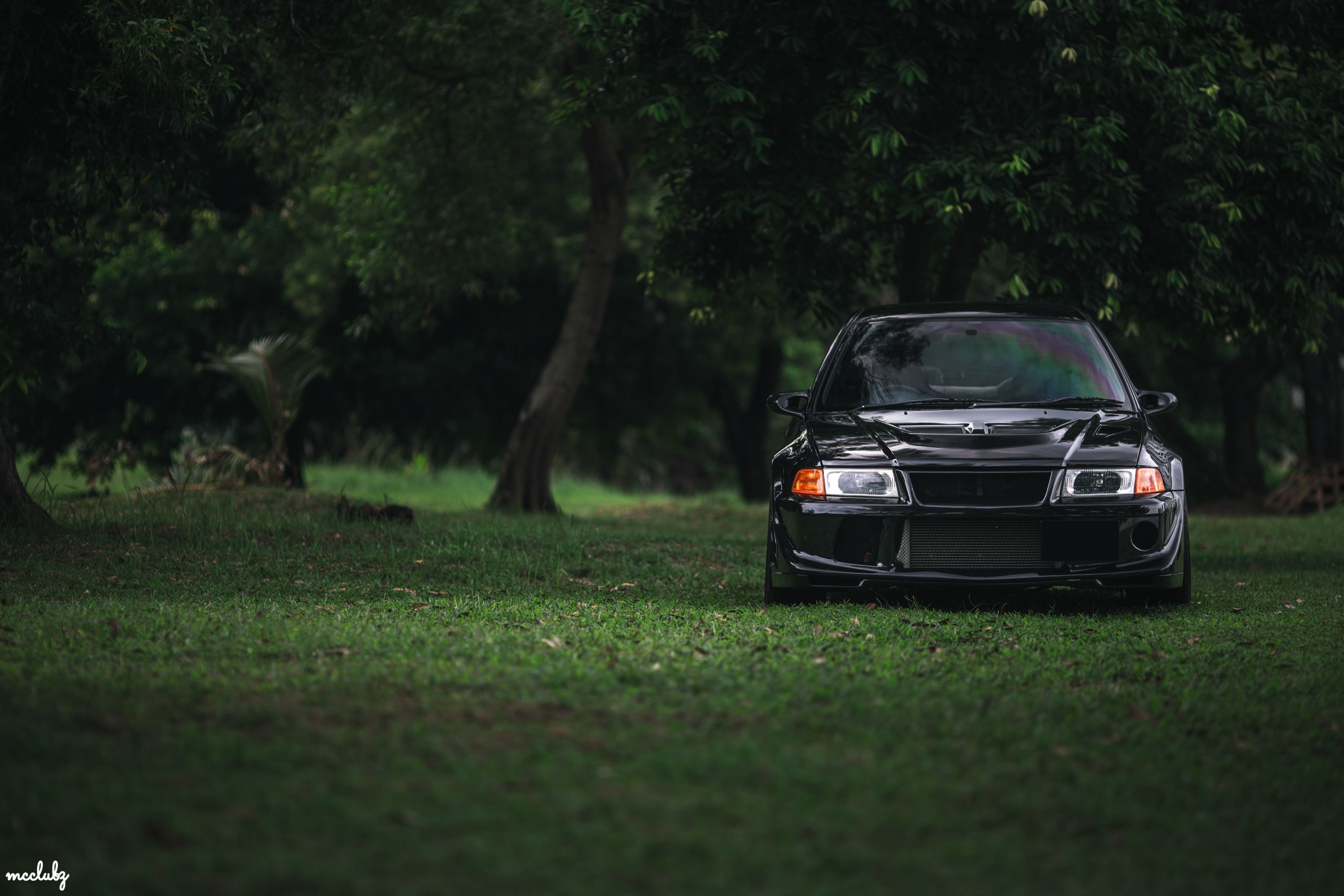 Black Mitsubishi Lancer Evolution VI parked on grass HD Wallpaper