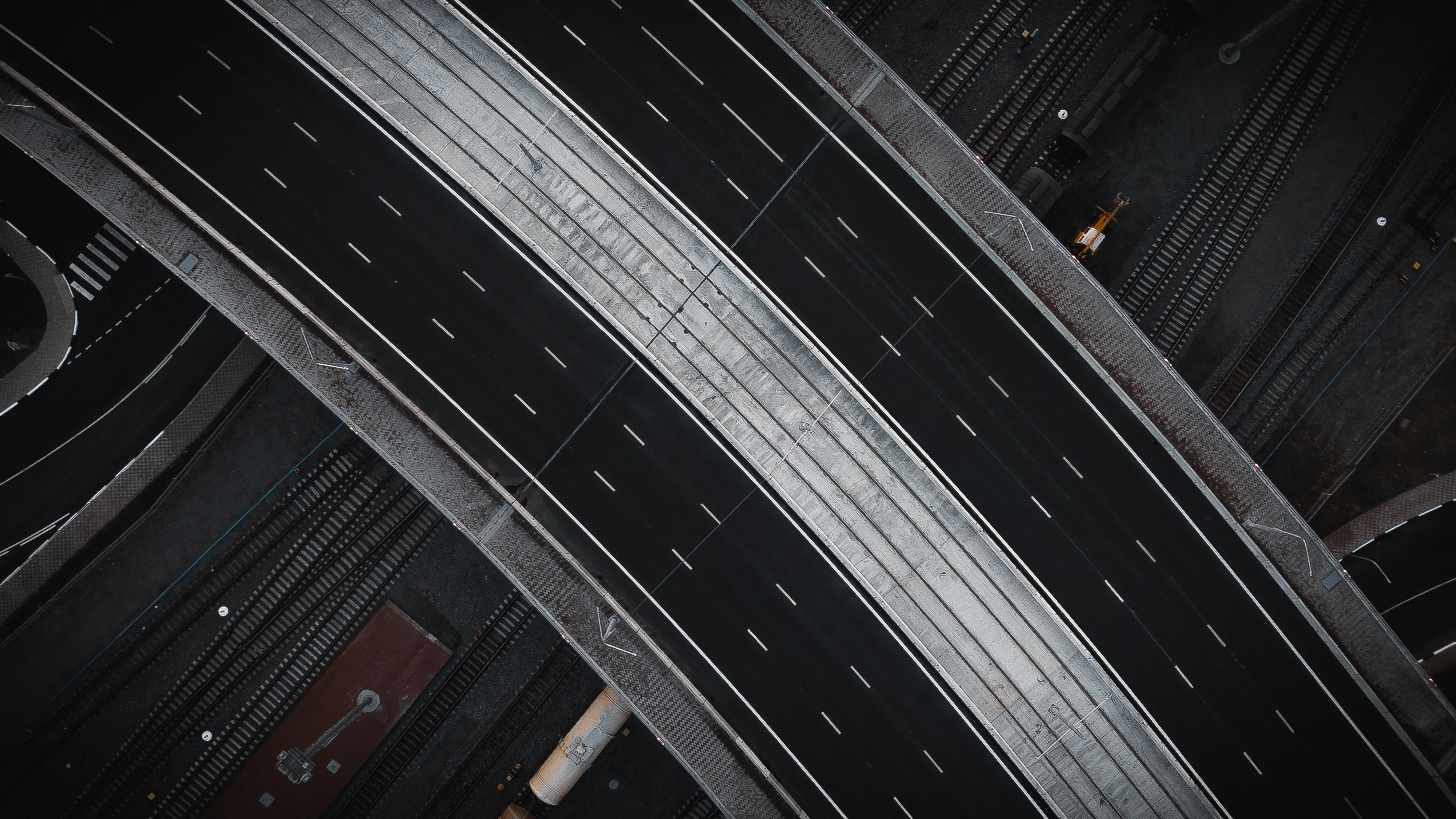 Aerial view of a highway overpass and railway tracks HD Wallpaper