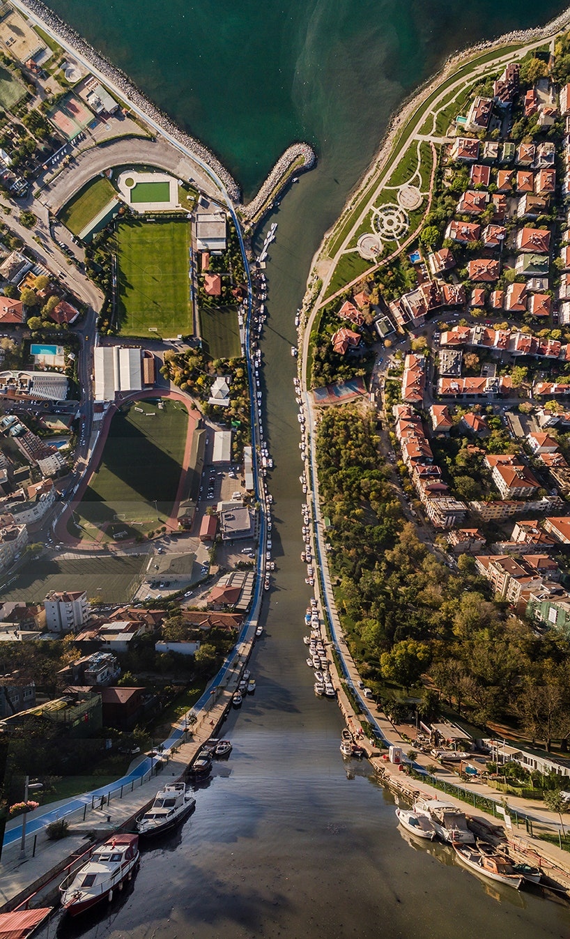 Aerial view of a coastal town with a river and boats HD Phone Wallpaper