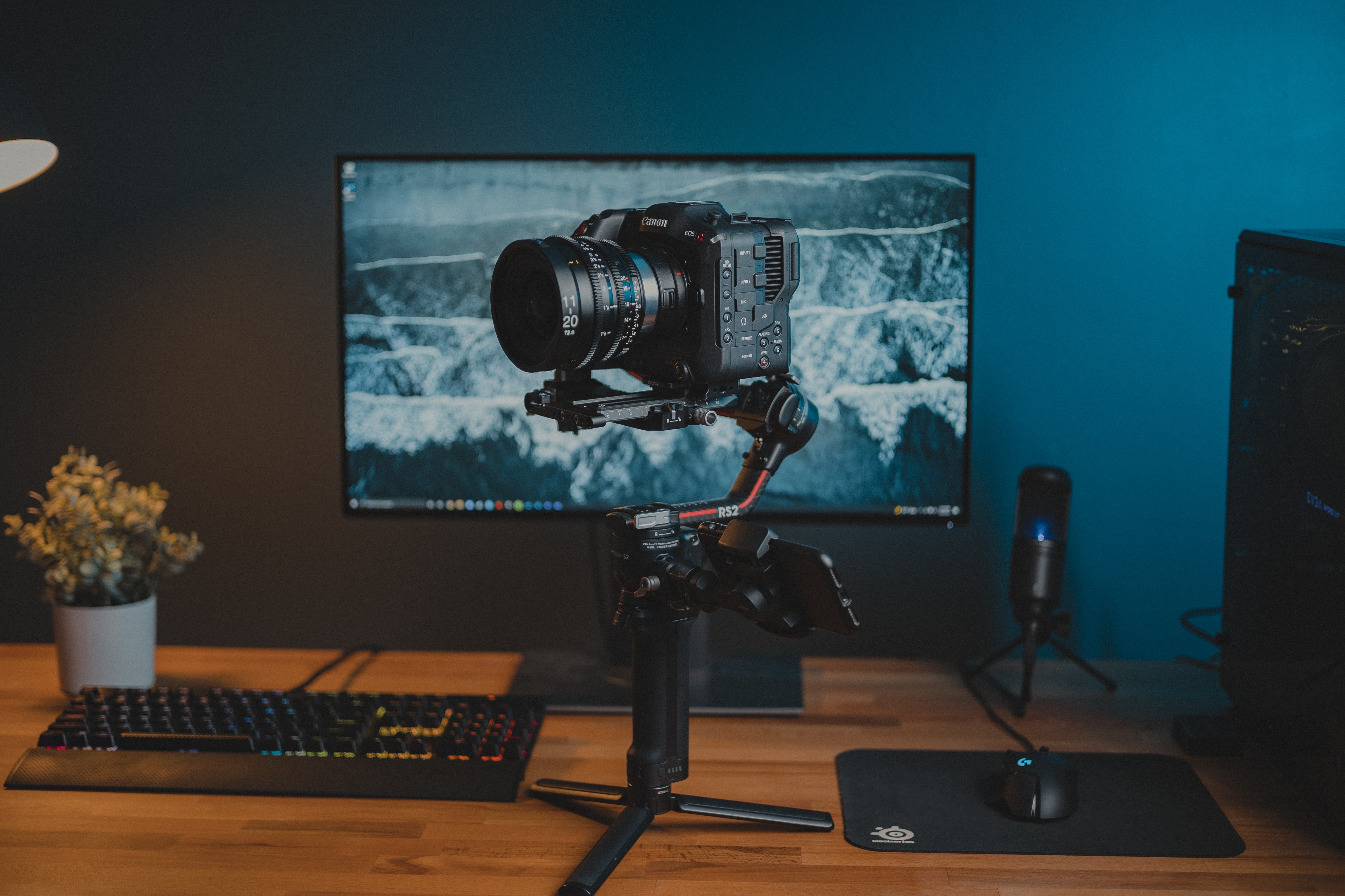 Canon camera on a gimbal in front of a monitor HD Wallpaper