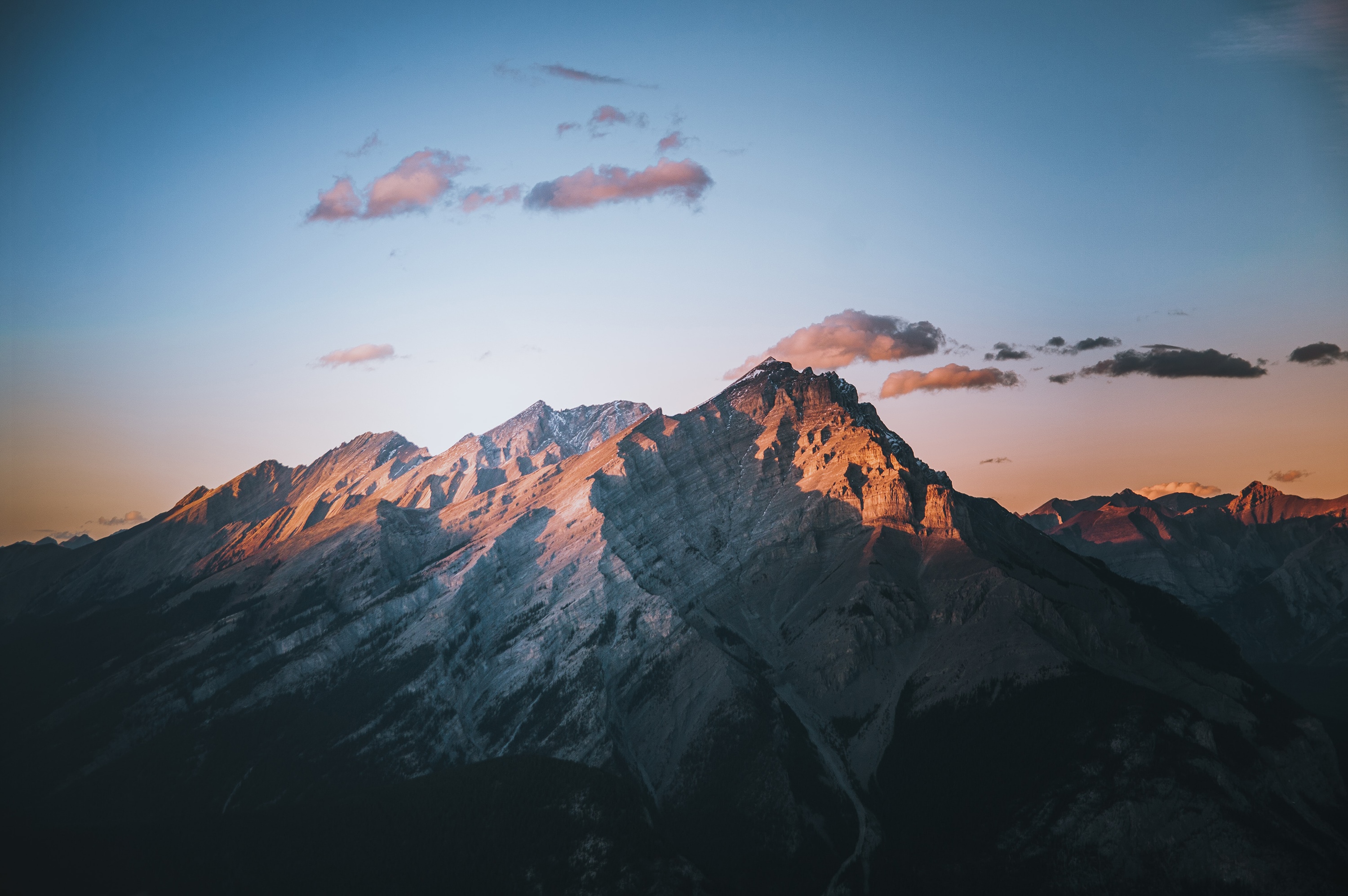 Sunlight on Rocky Mountains with Clouds at Sunset HD Wallpaper