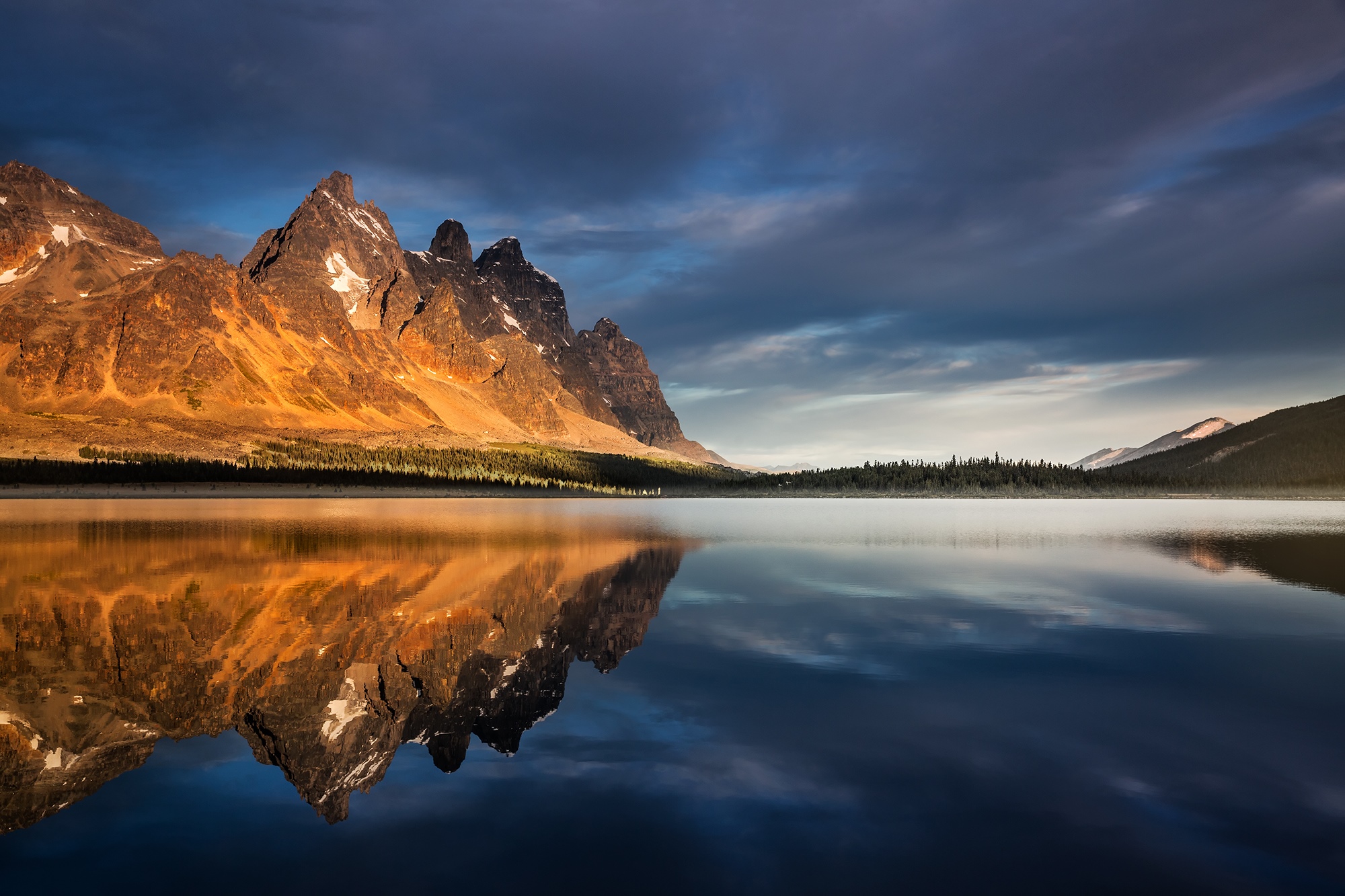 Mountains reflected in a lake at sunset in Jasper National Park HD Wallpaper